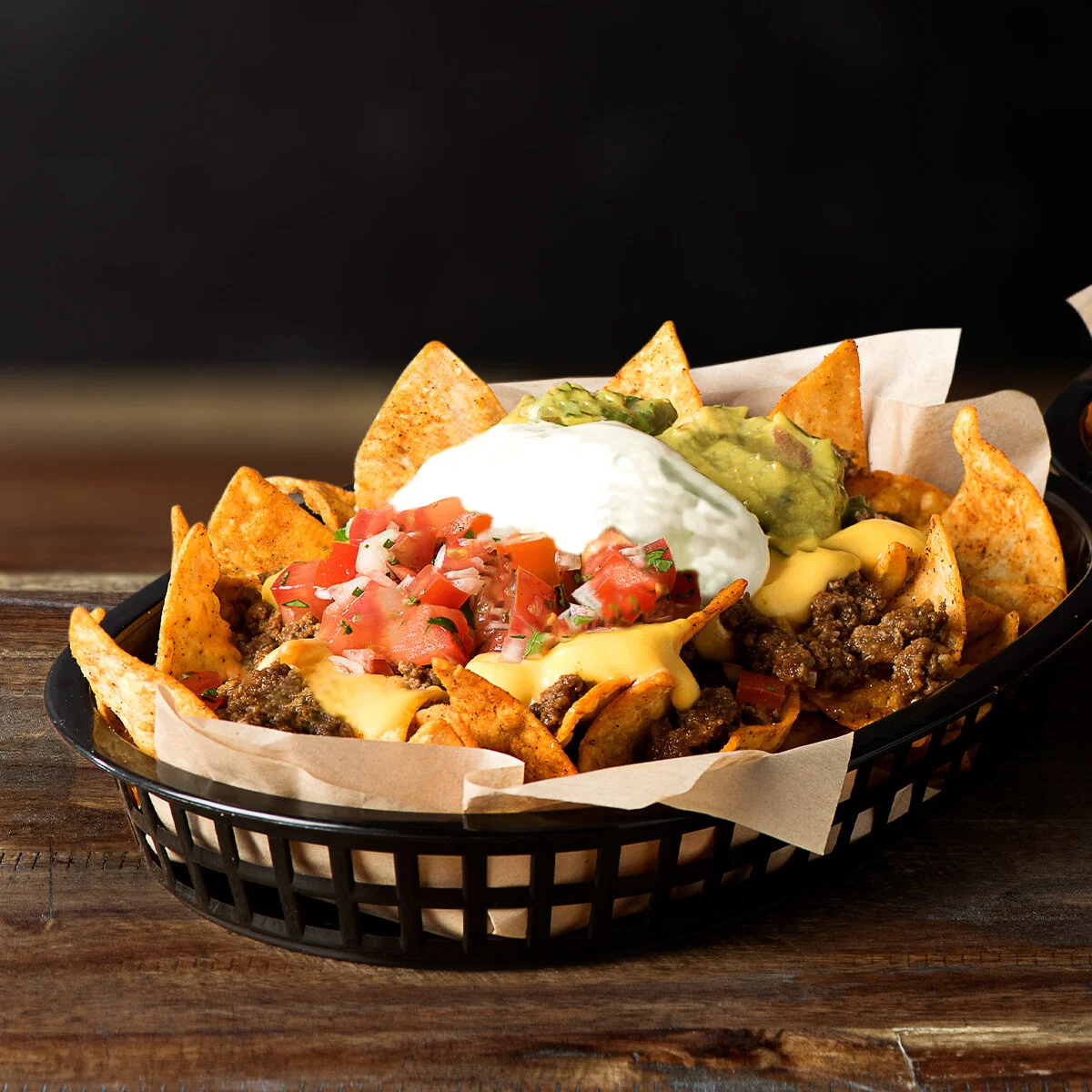 lOADED NACHOS  All the usual suspects stacked into this menu staple. With our seasoned tortilla chips, protein of your choice, sour cream, guacamole, and fiesta salsa.