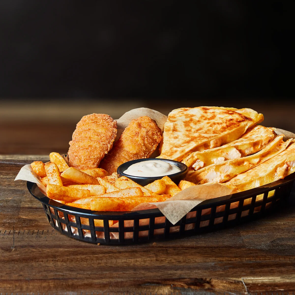 ASSORTED PLATTER  Looking for something to share? This is your go to, made up of a chicken quesadilla, crispy chicken strips, crunchy Mexican fries and creamy ranch sauce for dip.