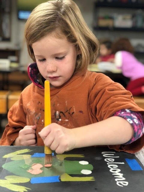 Another young girl painting