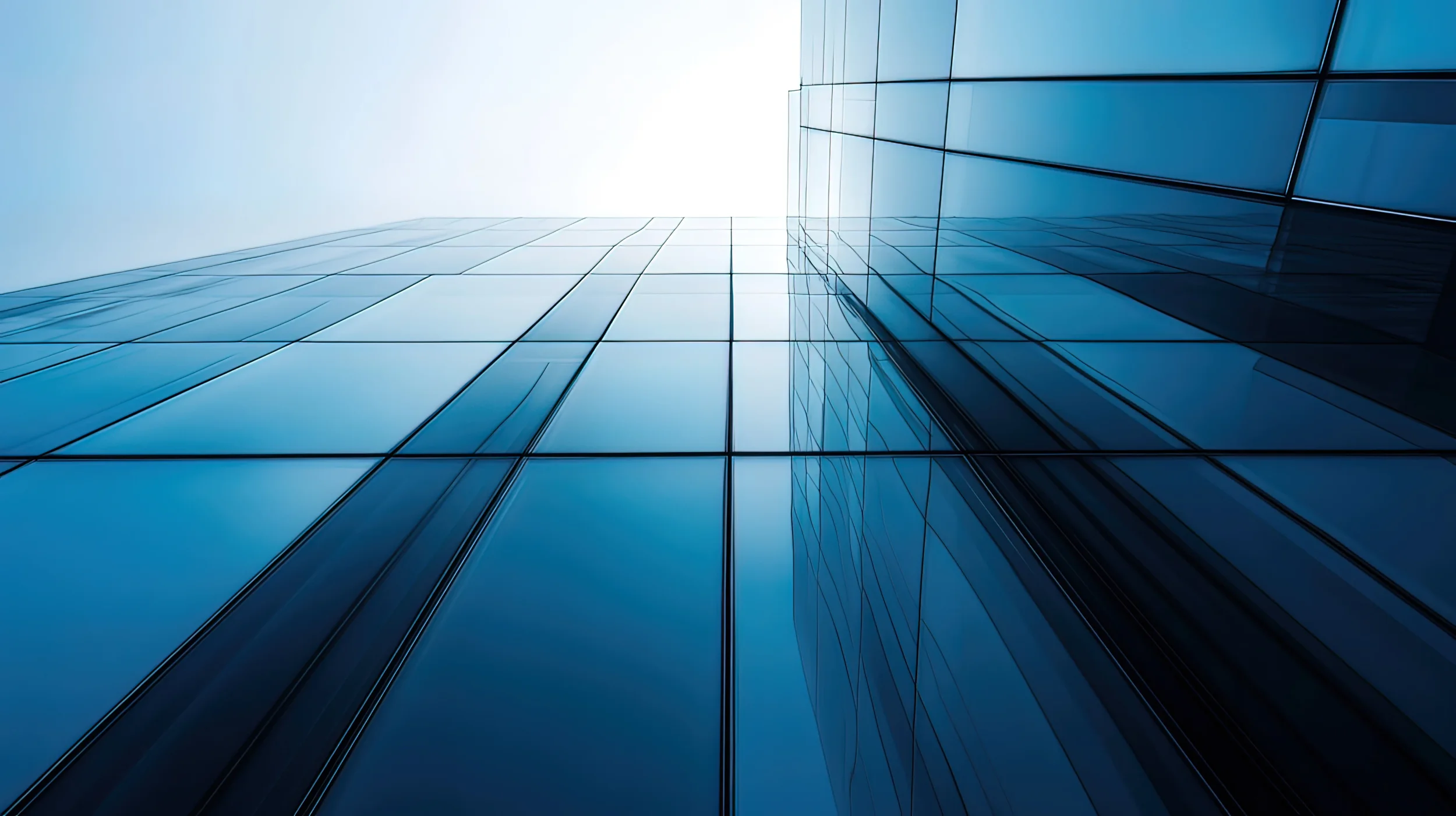 upward shot of glass skyscraper facade, blue tones.webp