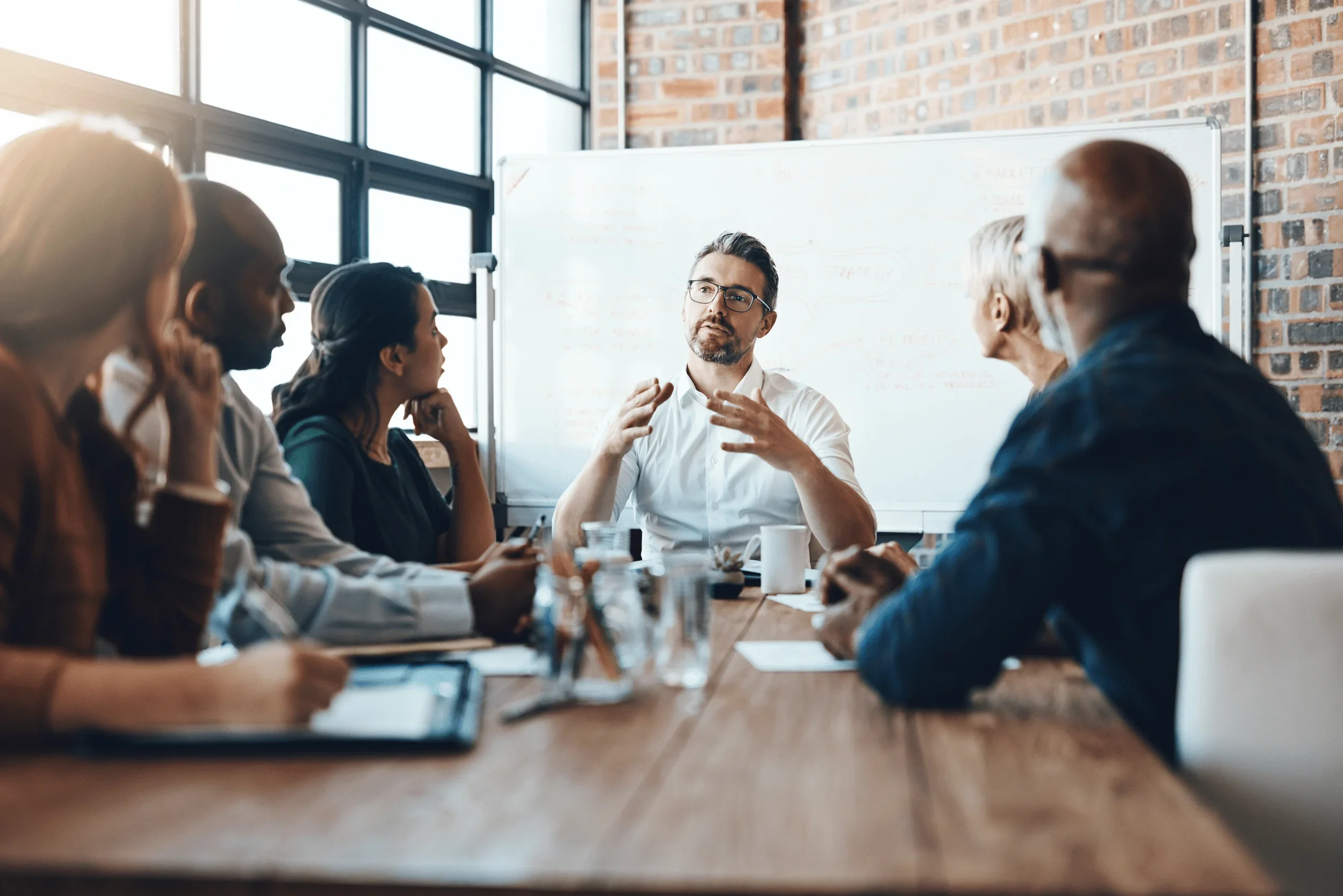 Professional services digital marketing strategy discussion with senior leaders around a boardroom table
