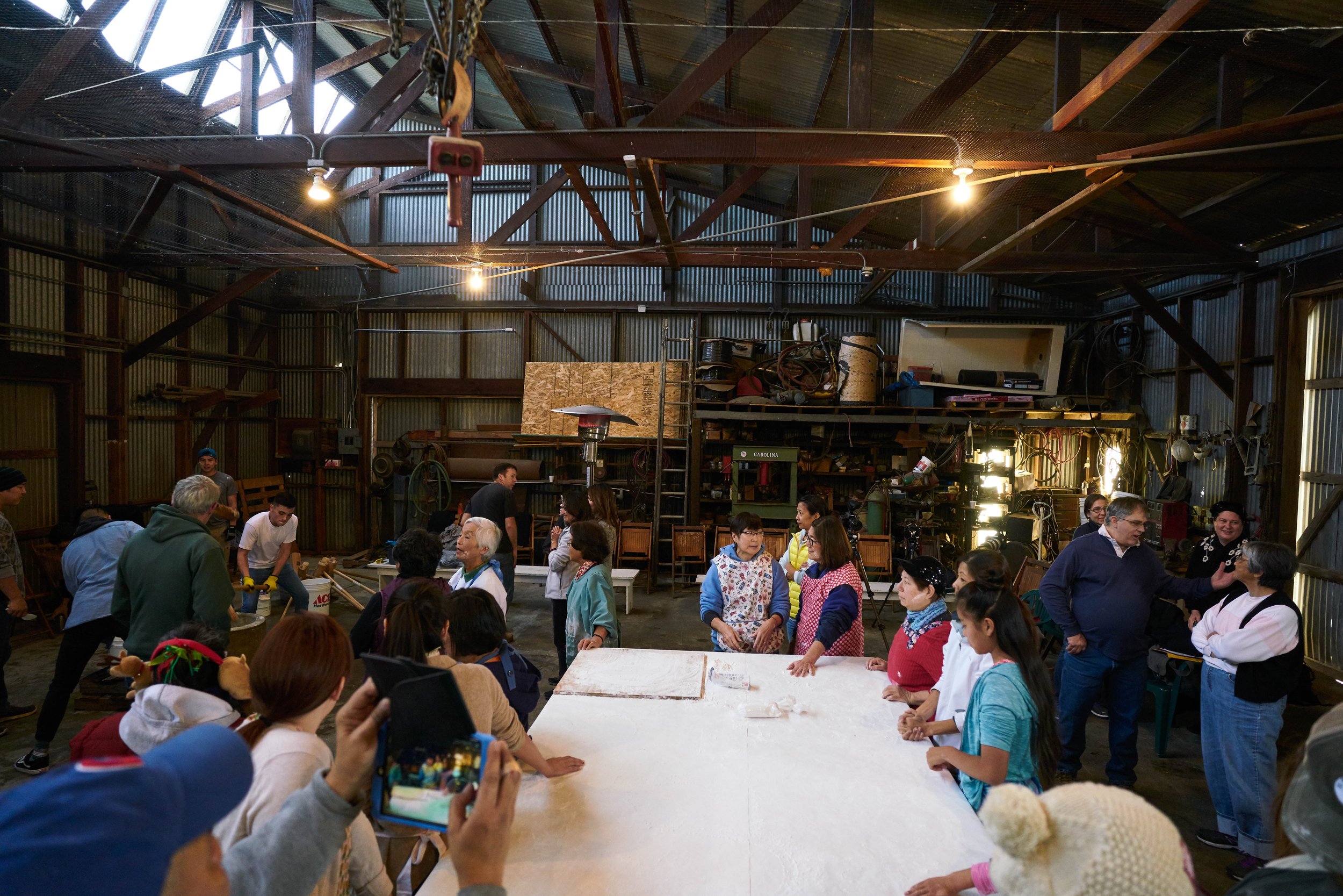 Many family members come together to make mochi.