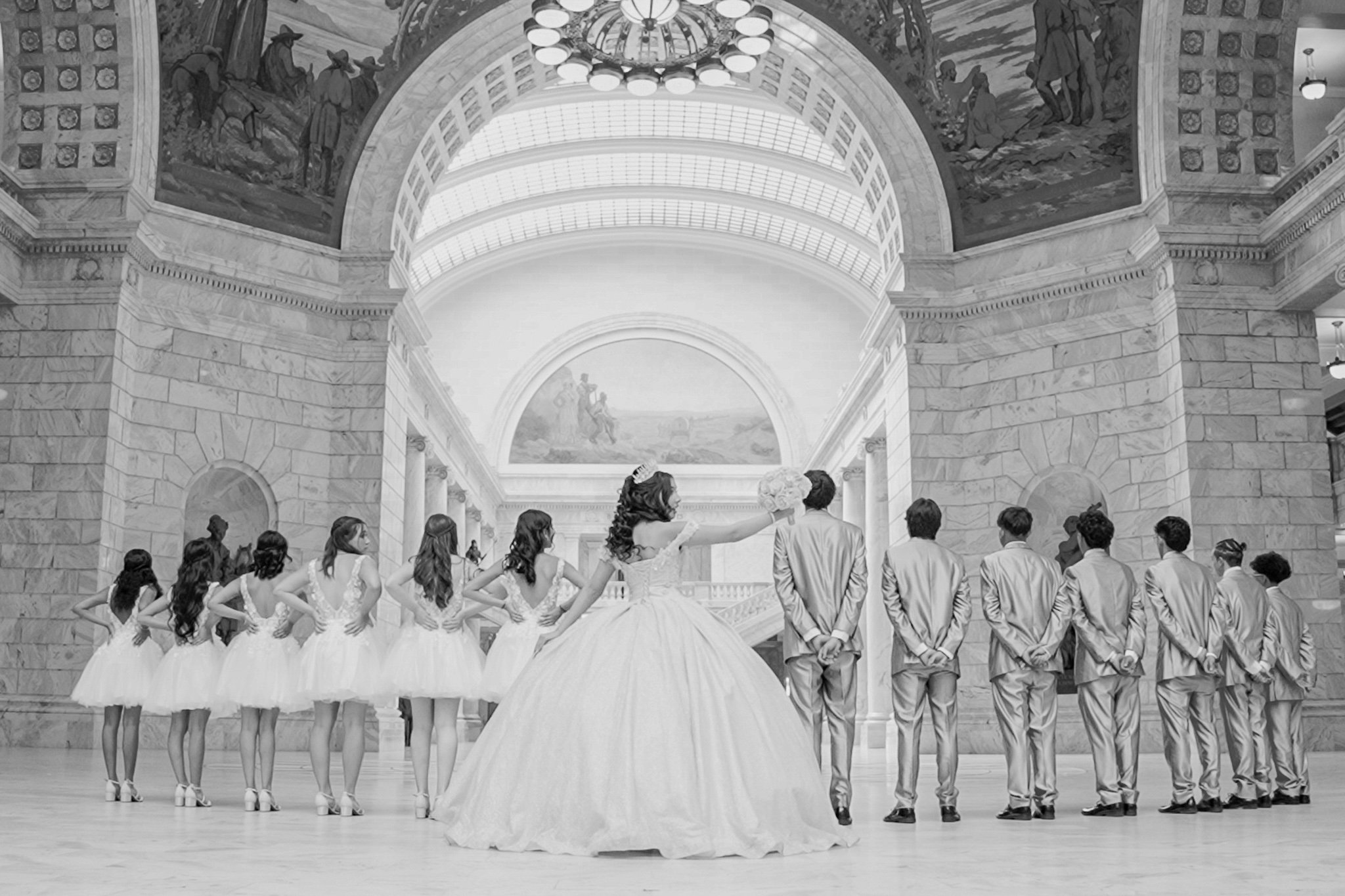 A group of highschoolers posing in the Salt Lake City Capitol building in Salt Lake City, Utah for a quinceañera.