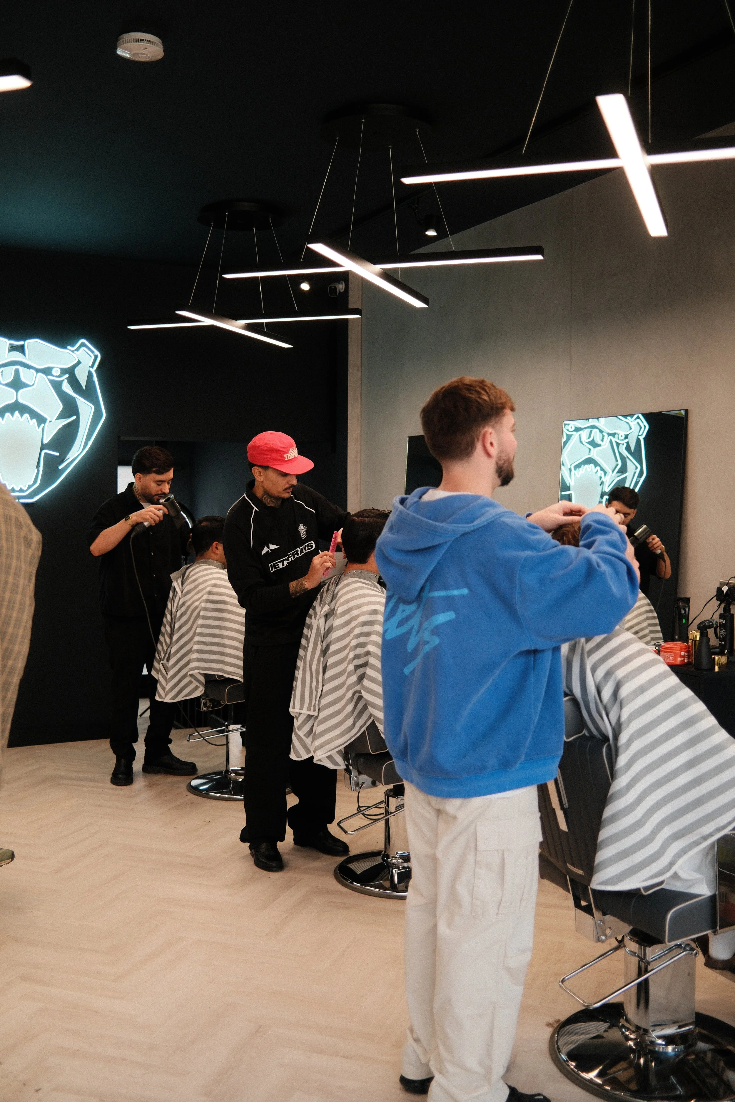 barbers cutting hair at fulham broadway barbershop