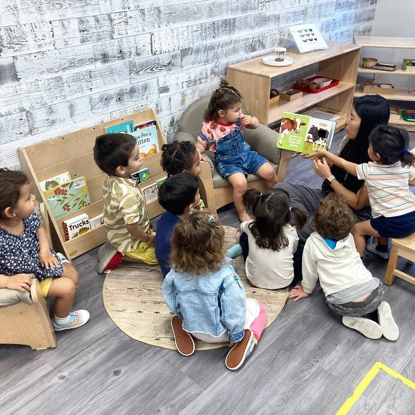 Reading with Ms. Pearl in the Coral Toddler Room. 😍