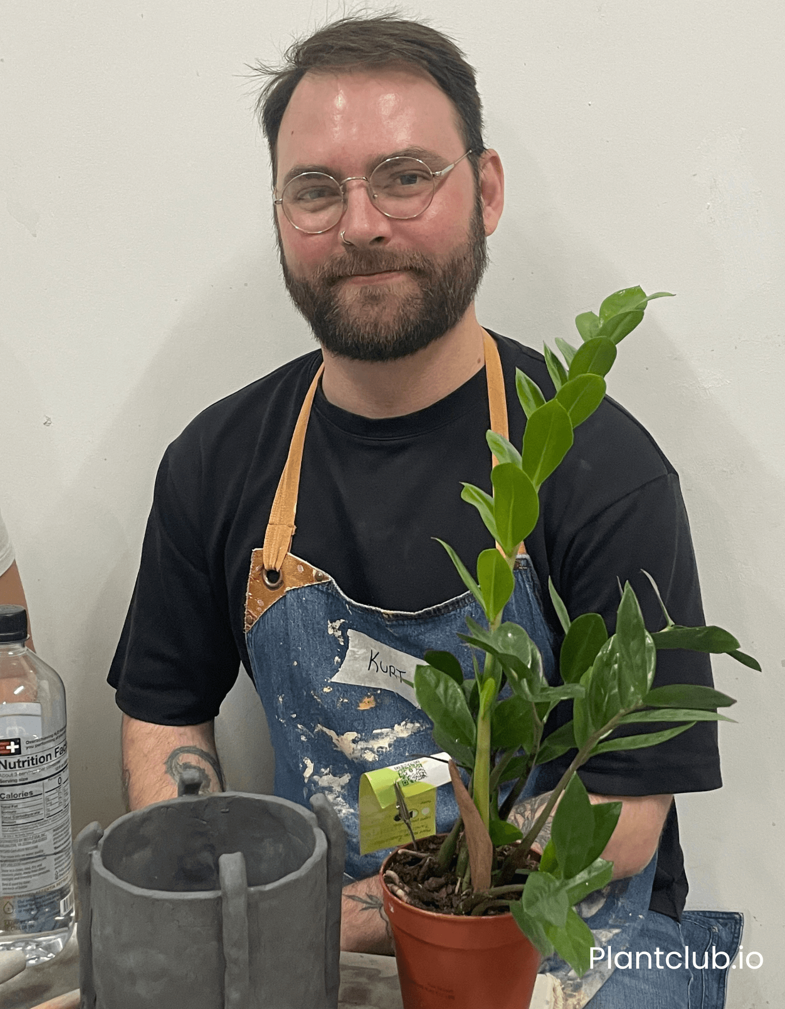 A person posing with his planter he made for his plant.