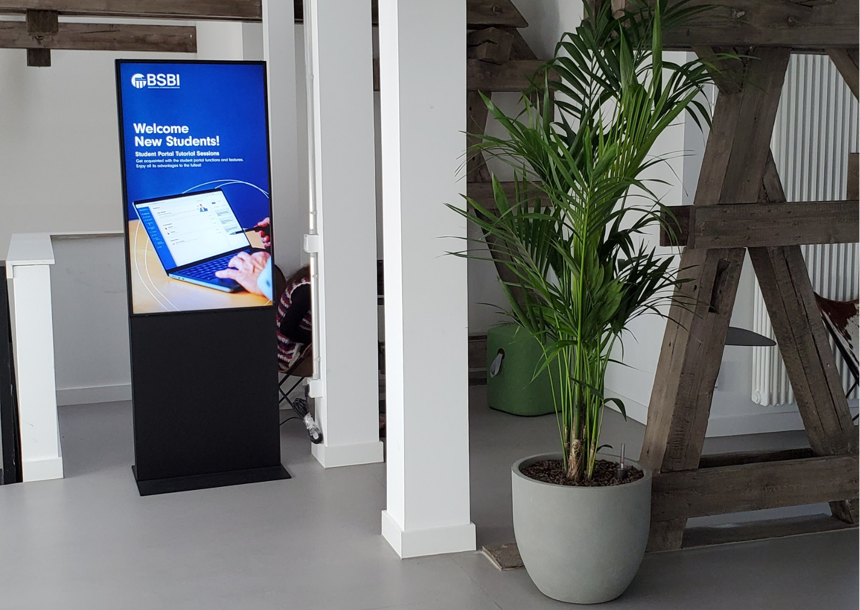  Part of the BSBI Berlin campus with a Kentia palm tree in a neutral pot to complement the color scheme. 