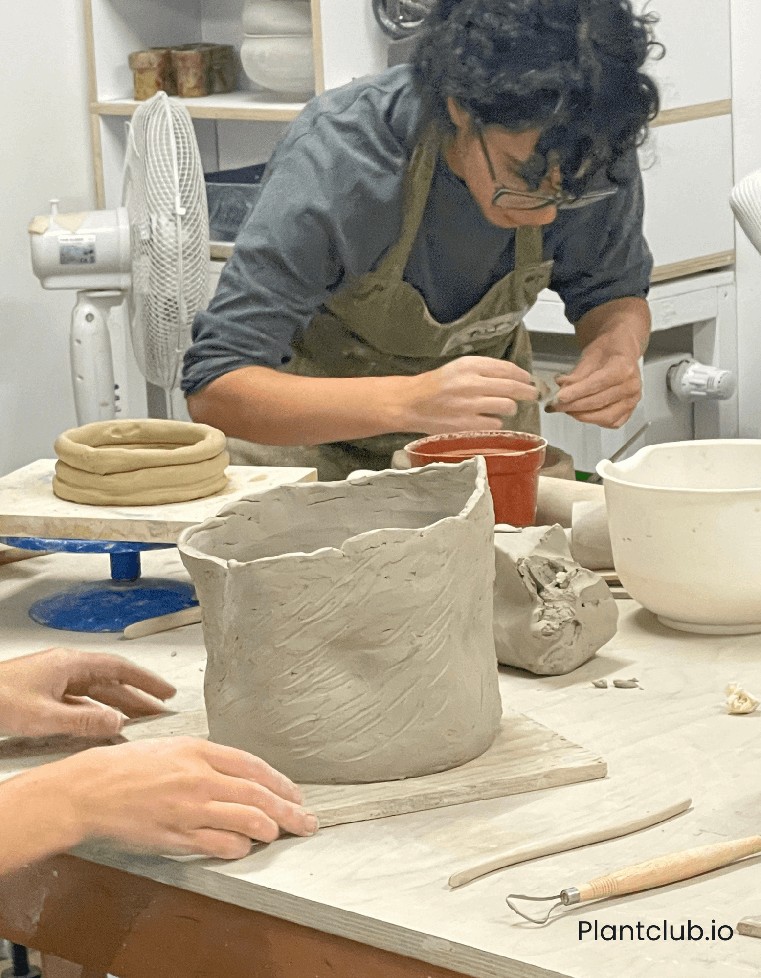 Two persons hand building a planter
