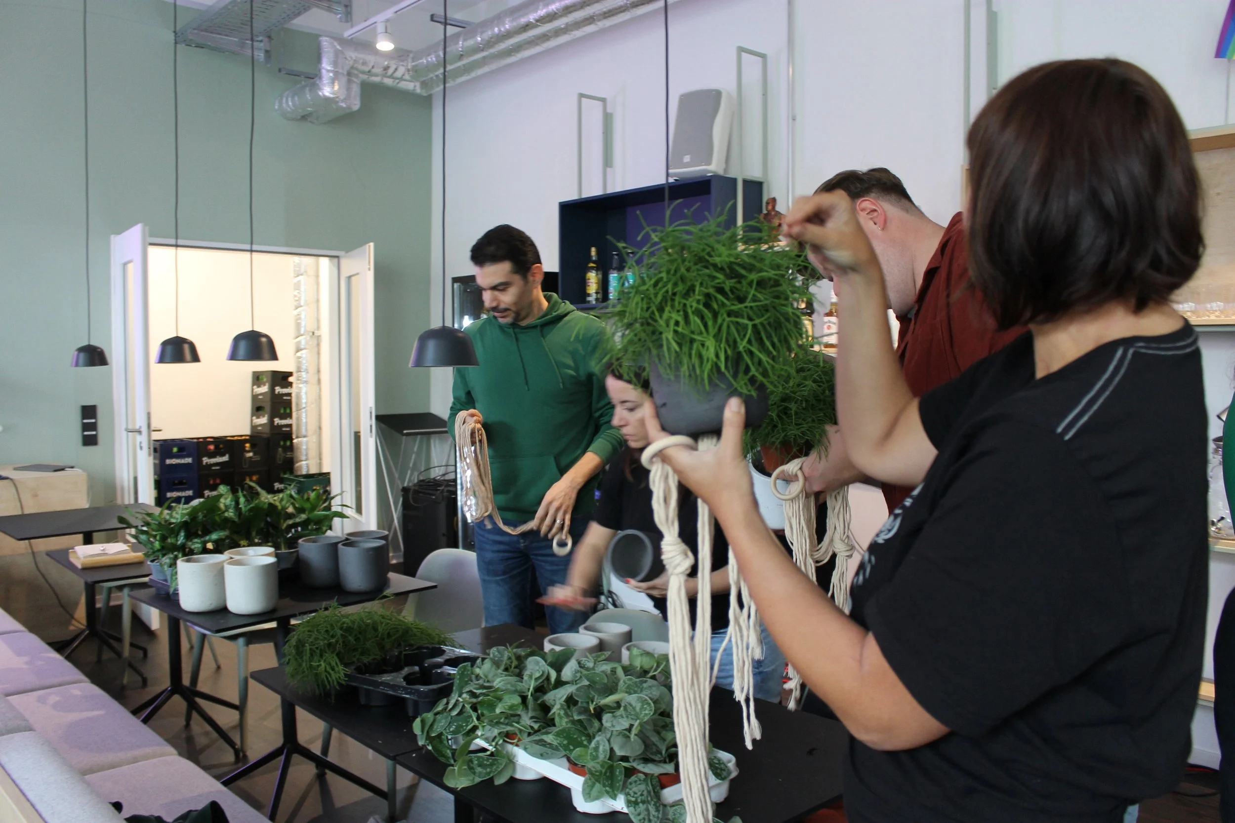  Employees participate in an autumn macrame workshop. 