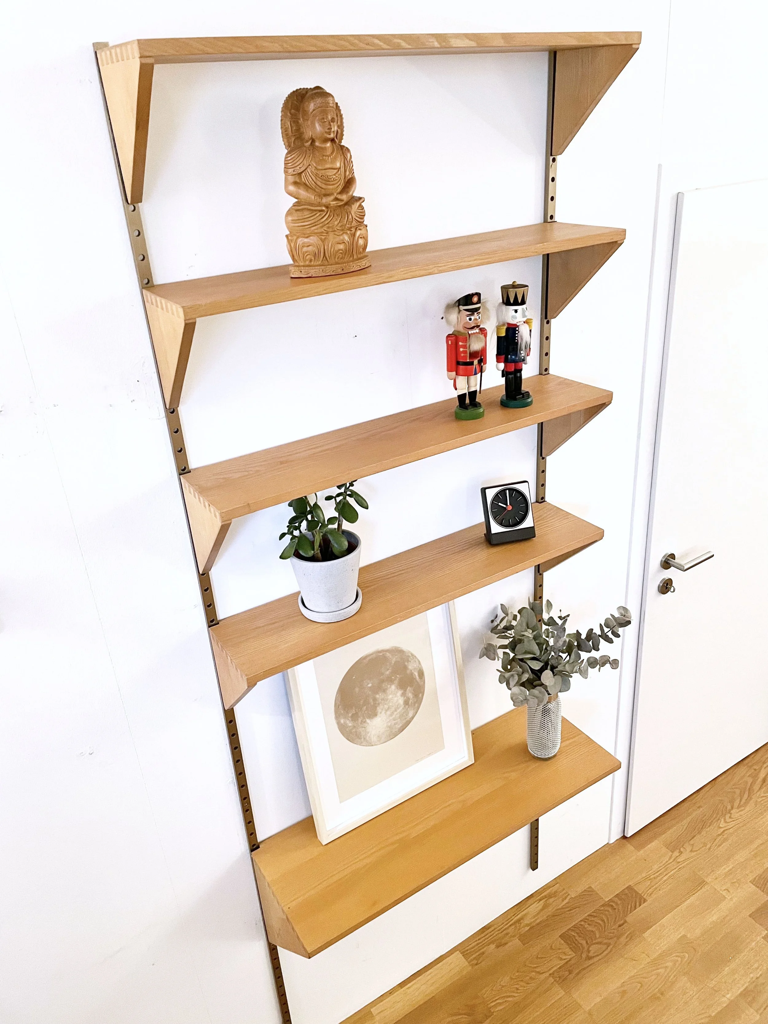 String modular wall shelf with two steel side elements and three walnut ...