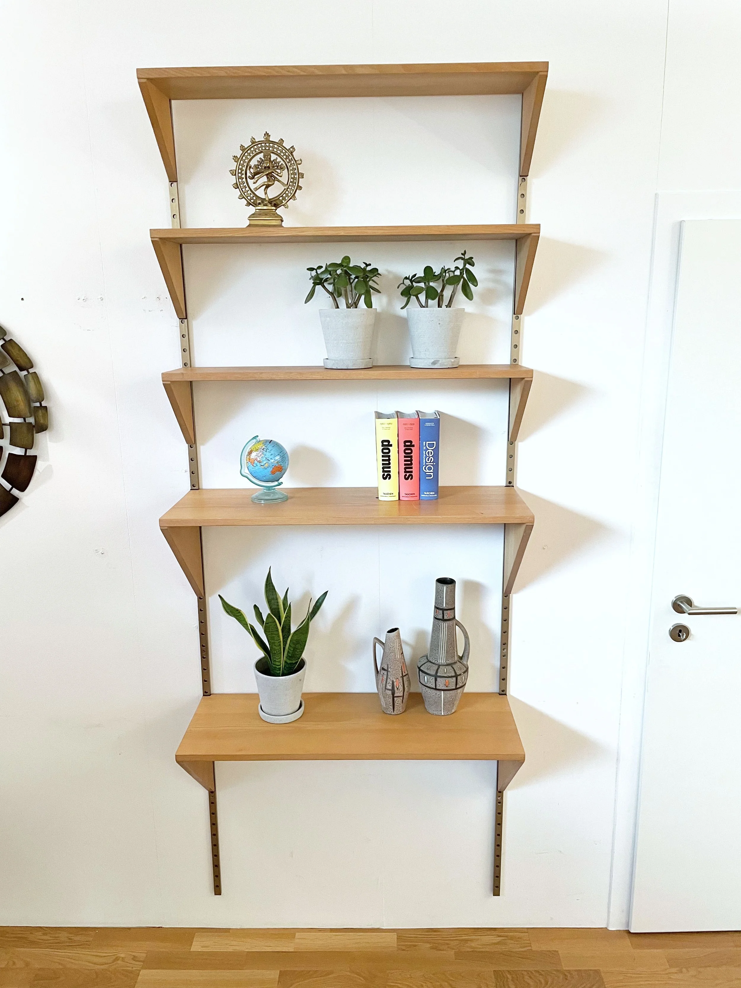 String modular wall shelf with two steel side elements and three walnut ...