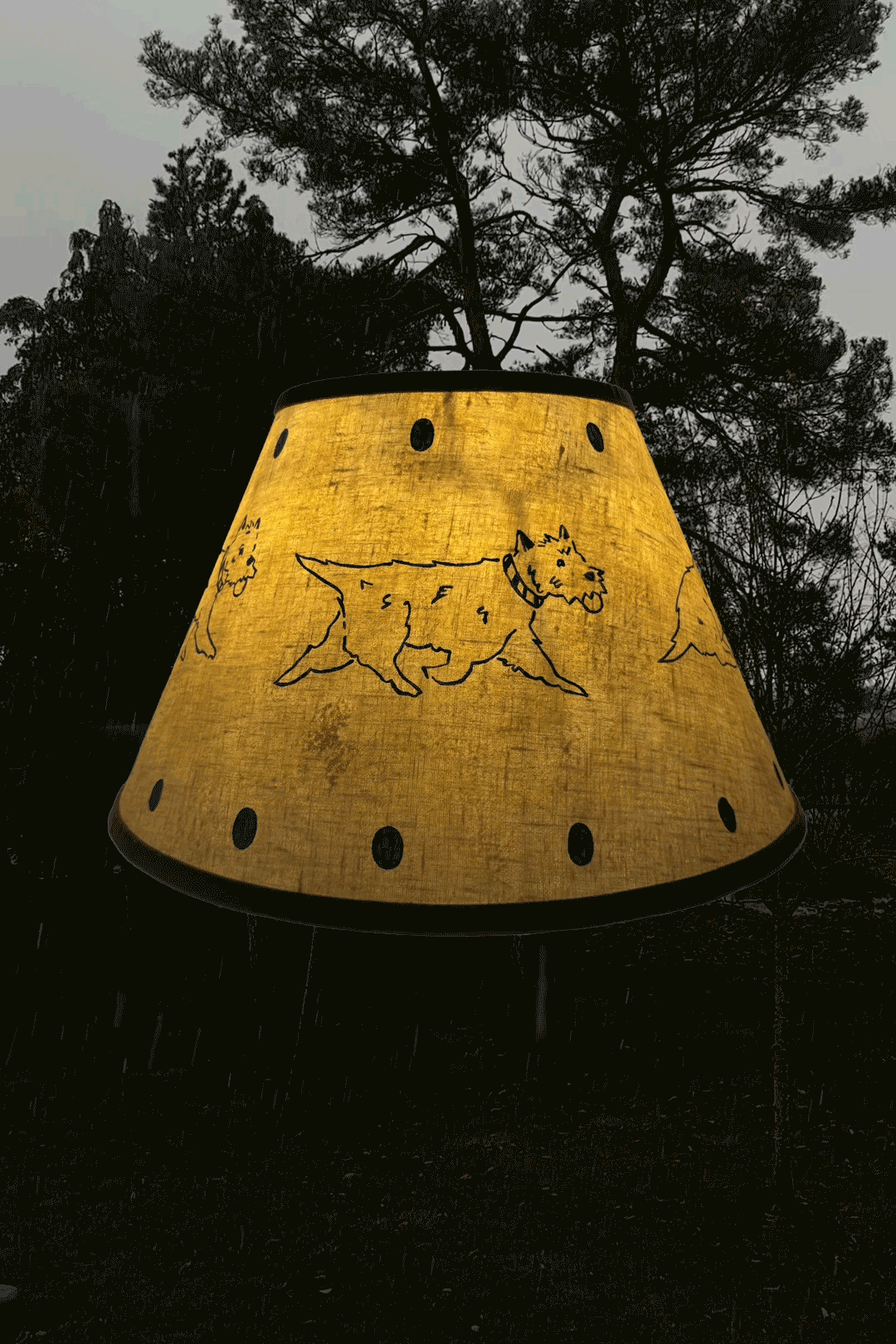 Trot linen lampshade by artist, Isobel Hill. Lamp is rotating whilst glowing, snow falls in the background.