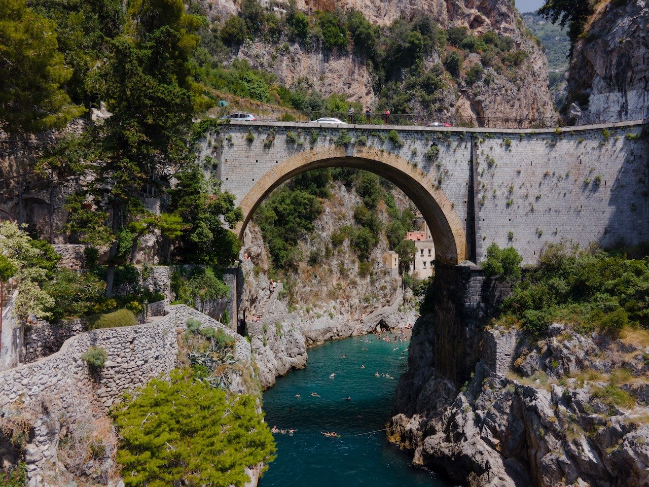 📍 Fiordo di Furore, Amalfi Coast, Italy

Quite possibly one of the coolest beach settings I have ever been to. Get here early if you want a decent spot and to beat most of the crowds. This beach is perched just behind this bridge along the Amalfi Co