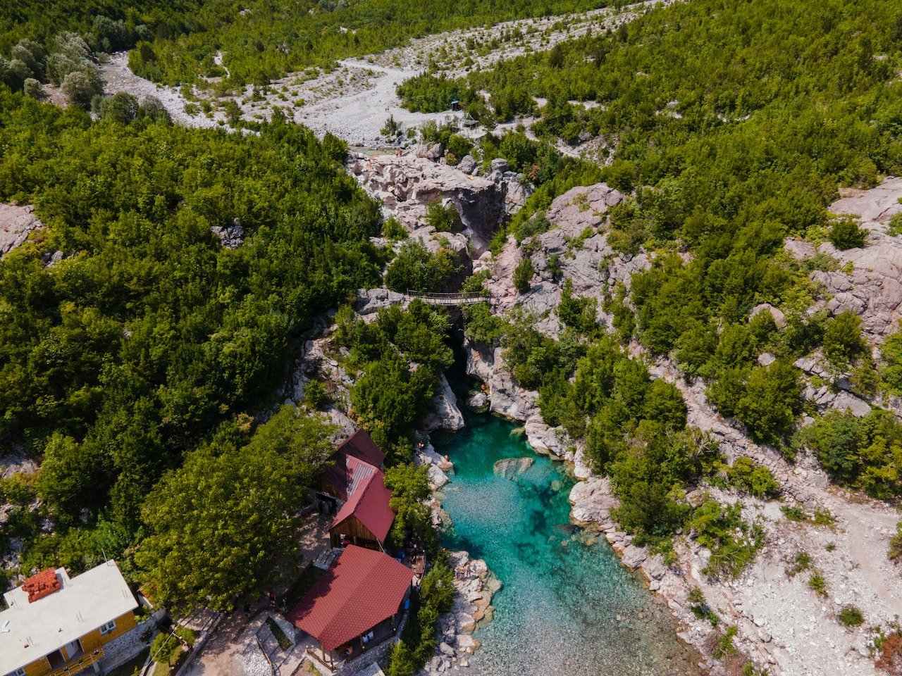 📍 Theth, Albania

The Blue Eye near the village of Kaprre is probably the most well known attraction in Theth. It is part of the Thethi National Park and is essentially a well of 100 square meters and about 5 meters deep. The water source is from th