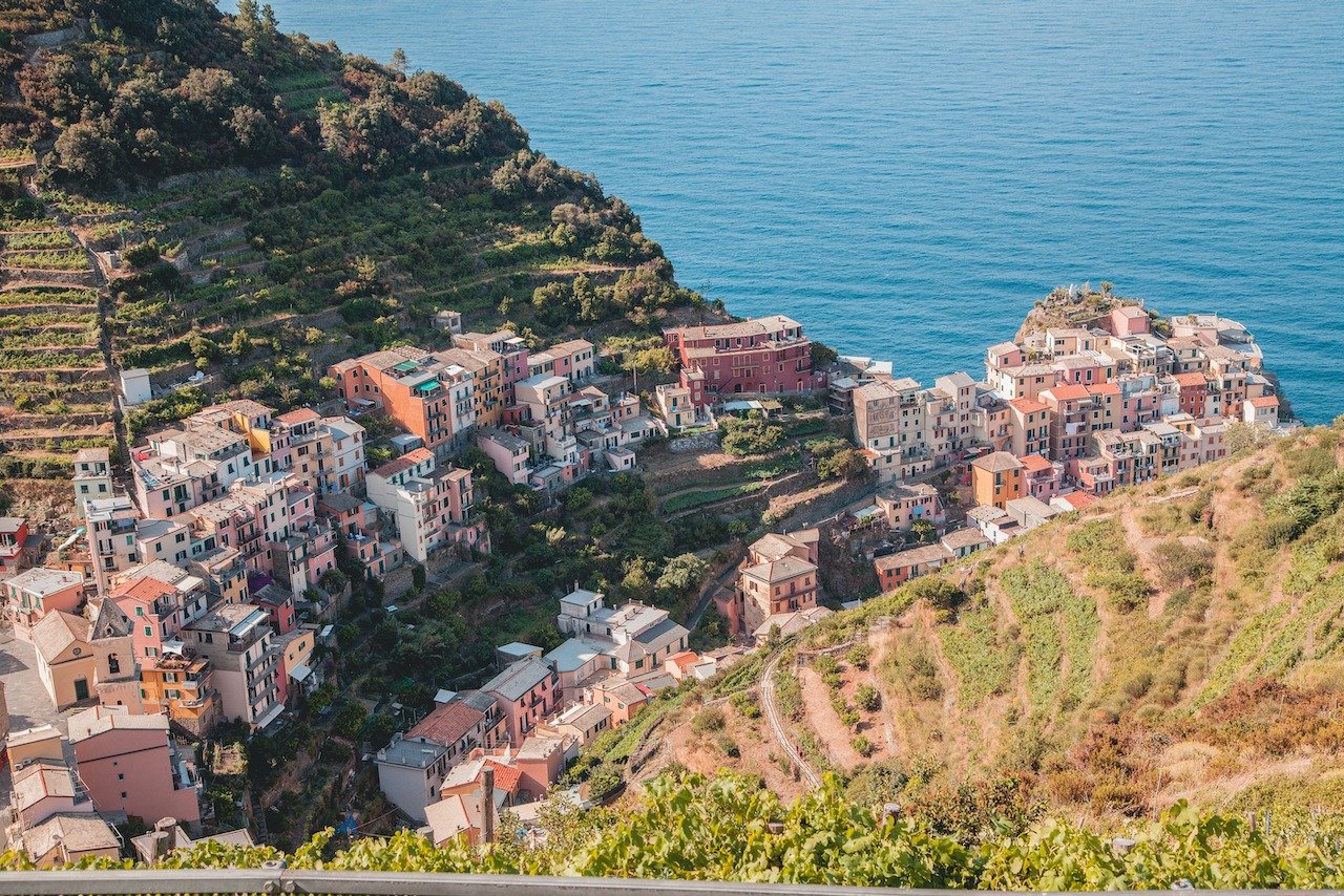 📍Manarola, Liguria, Italy

You can get this view of Manarola by hiking up the cliffside, towards the next town of Corniglia. The first 30 minutes are absolutely brutal since you are ascending up the mountainside. But I must say, despite the exhausti