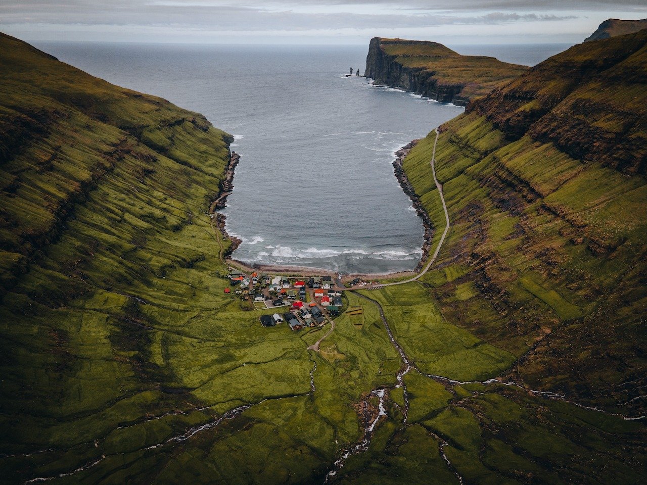 📍Tj&oslash;rnuvik, Streymoy, Faroe Islands

Tj&oslash;rnuvik is a small village, located on the northeast coast of Streymoy, situated in a valley that feeds right into the North Atlantic Ocean. There&rsquo;s only 55 homes there and even the road get