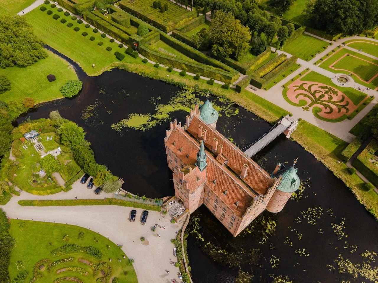 Seen from above, Egeskov&rsquo;s gardens reveal a level of precision and artistry rarely found today. Perfectly shaped hedges, reflective water, and geometric patterns turn the grounds into living architecture. This is landscape design elevated to an