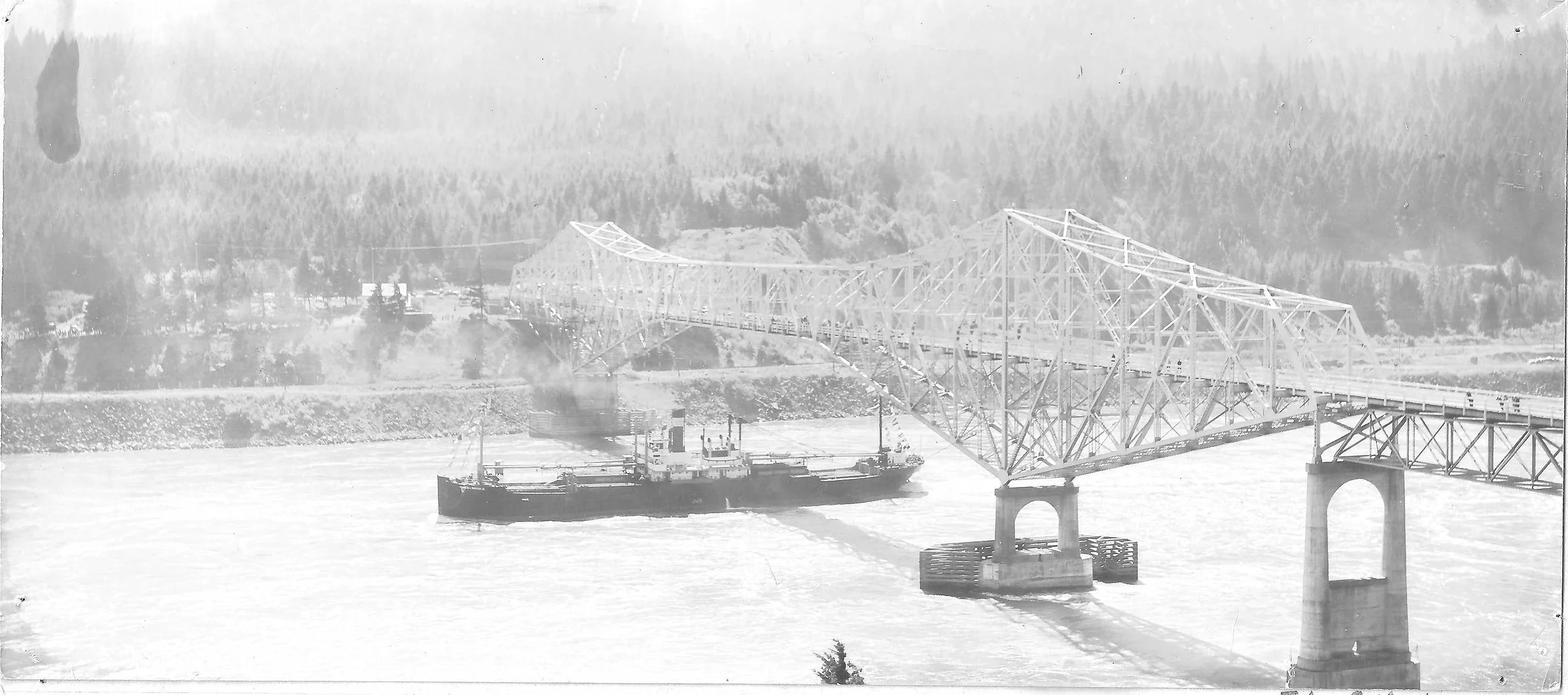 SS Charles L Wheeler Jr, first deep sea freighter to go throught he locak at Bonneville, passes under the Bridge of the Gods in 1938 before the lift. There is very little clearance between the ship and the bottom of the bridge.