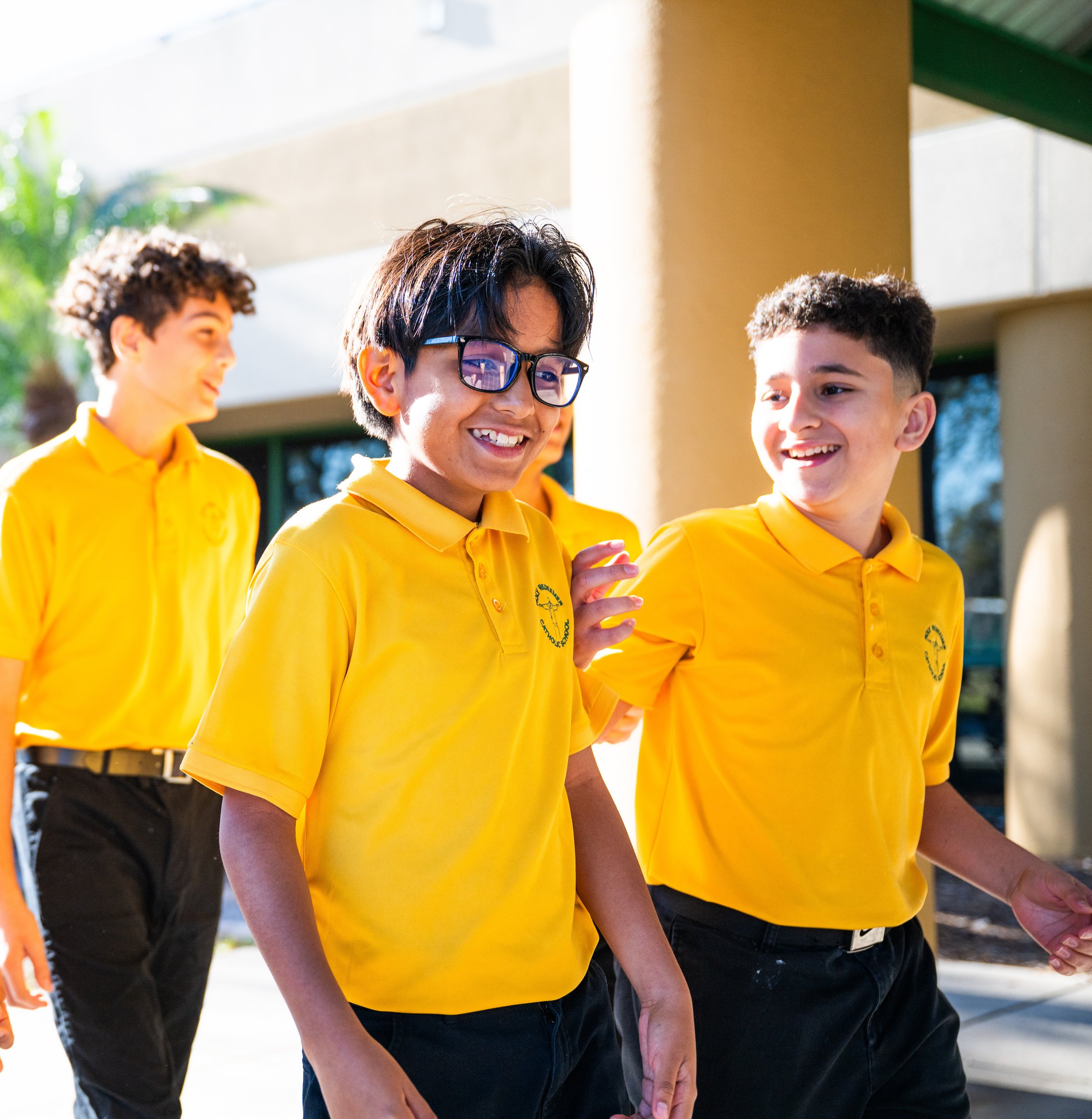 Group of students in yellow uniforms standing together outside