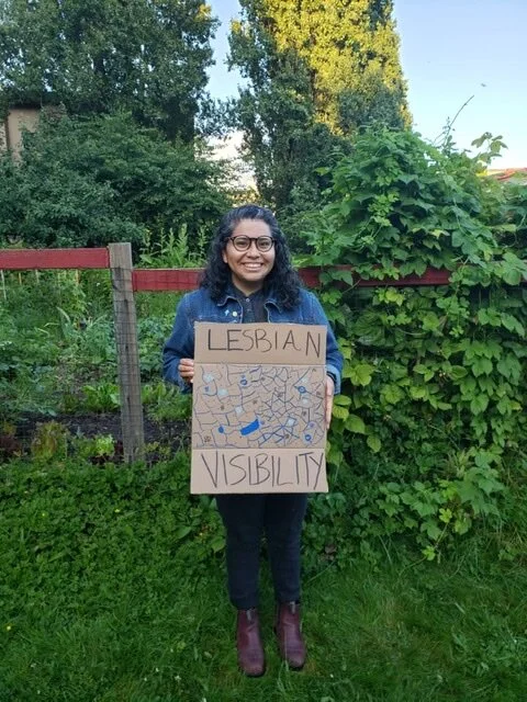 woman-garden-sign-dyke-march-2020