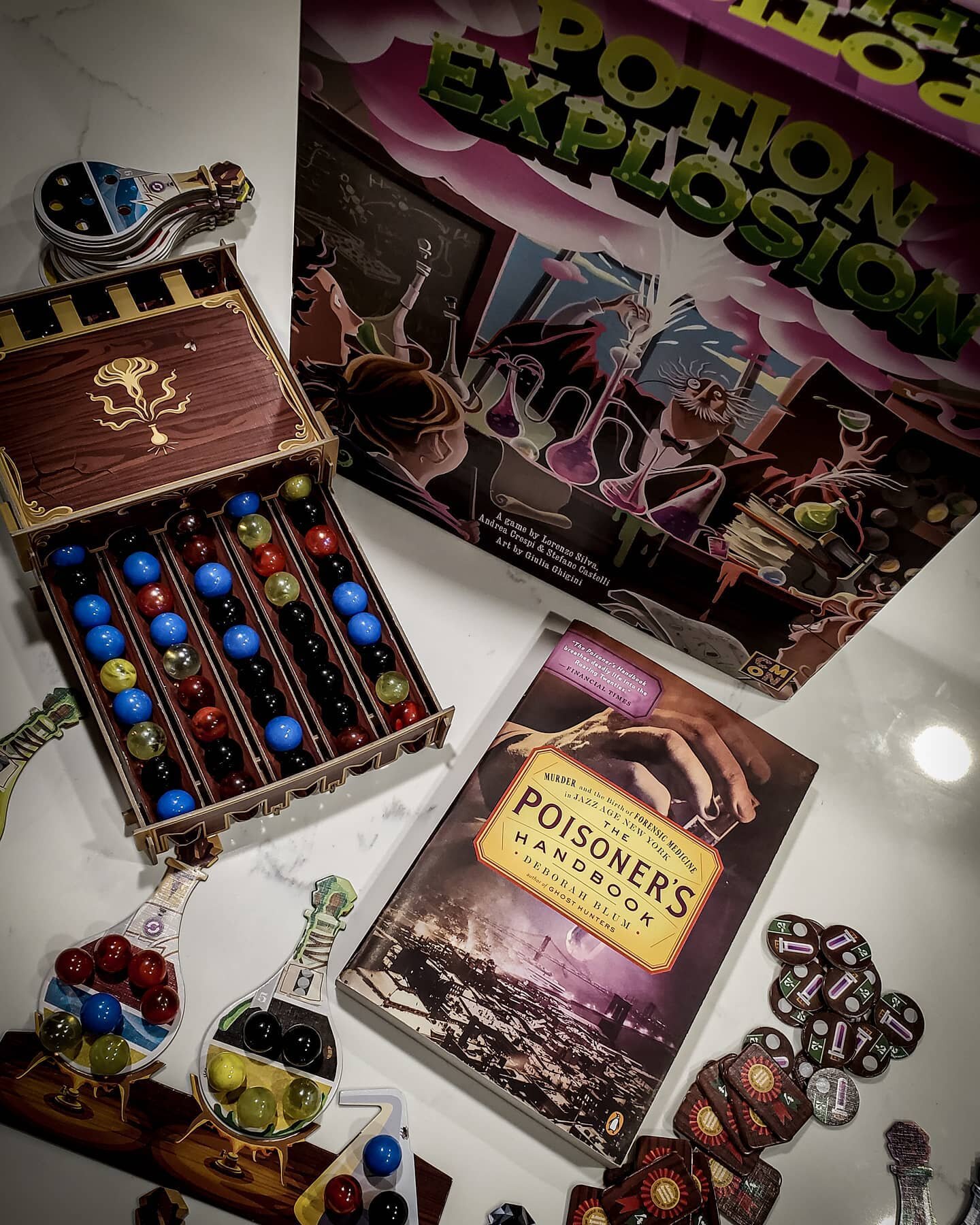 The other day we played one of our favorite games, Potion Explosion. I decided to take start a fun new series of pictures of #booksandboardgames (I say start but as I typed the hashtag I see it has been used before). So I have paired it here with The