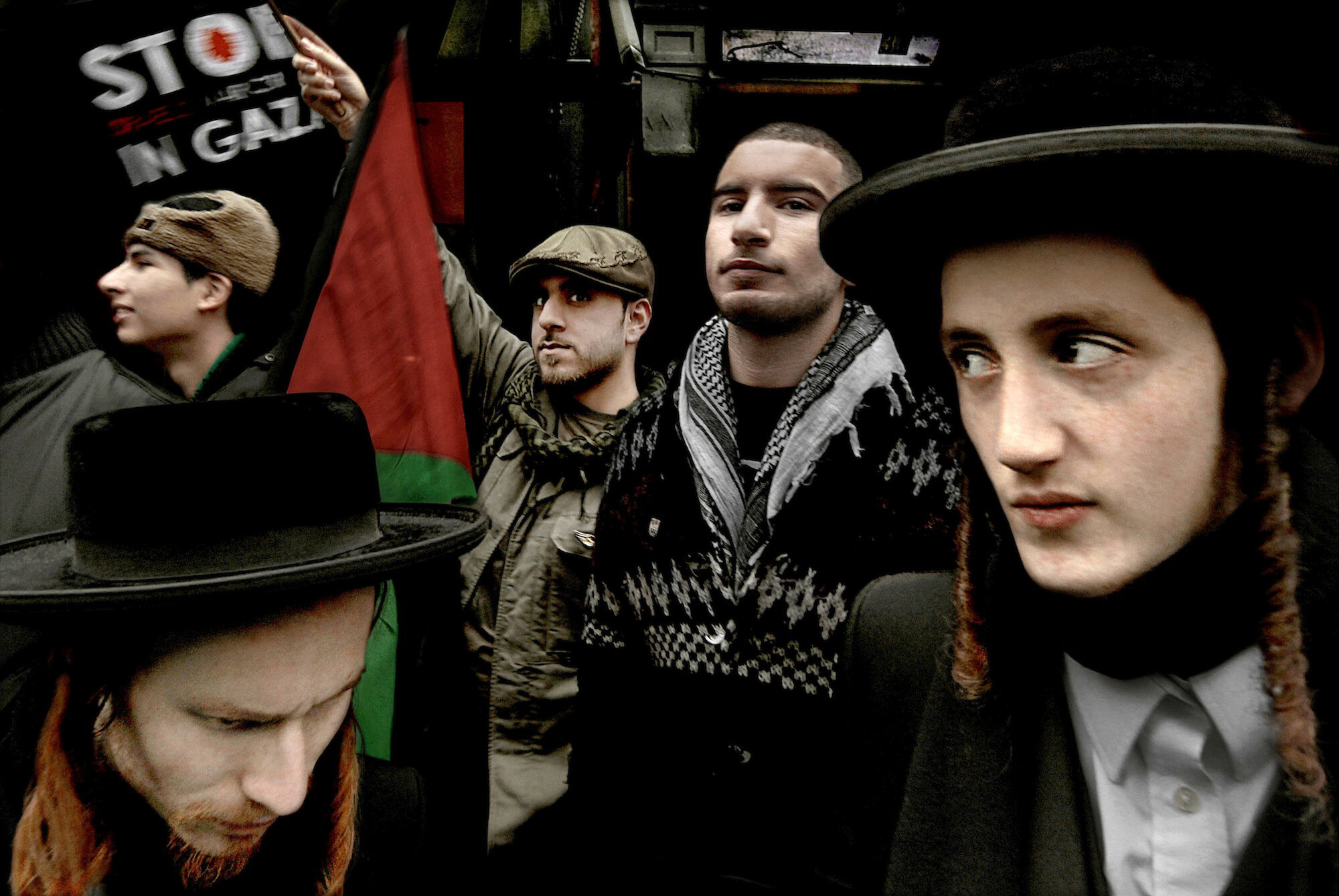   UK. London. 2011. Muslims, along-with members of Neturei-Karta, an organization of Orthodox Jews, protest outside the Israeli Embassy to mark the third anniversary of Israel’s attack on Gaza. Members of Neturei-Karta refuse to recognize the existen
