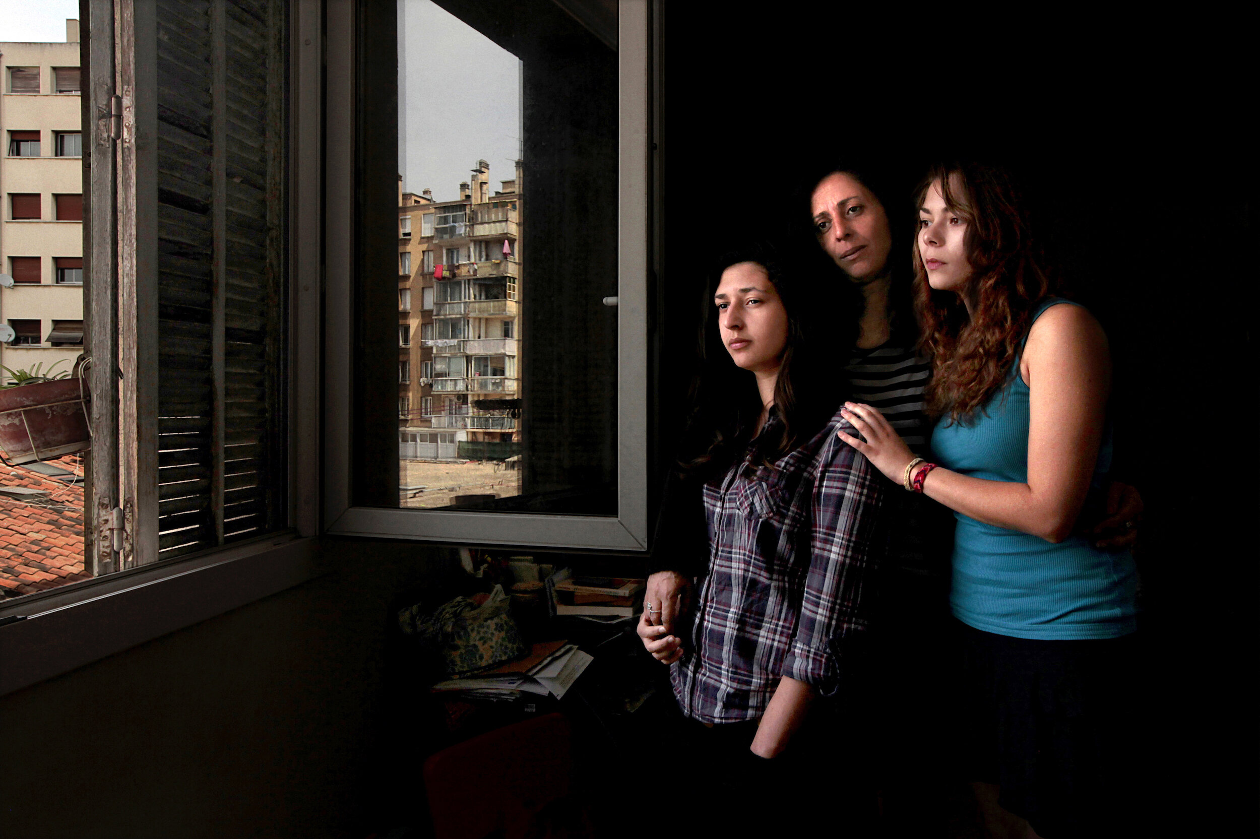    France. Marseille. 2014. Radia (center) with her daughter (left) and her friend (right) at her home in the 3rd arrondissement of Marseille.        
