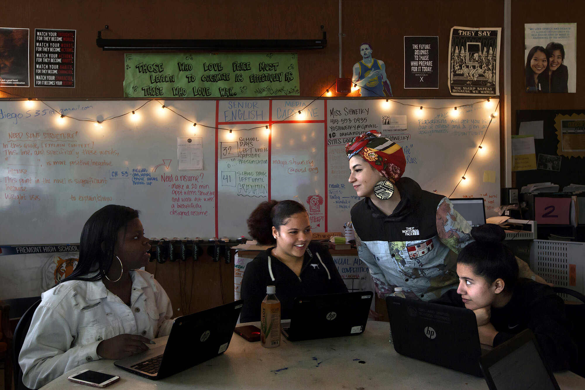   USA. Oakland, California. March, 2018. Maya Shweiky (second from right), 27, a high school English teacher, interacts with her students during a class at the Fremont High School, East Oakland. More than eighty percent of the students at Fremont Hig