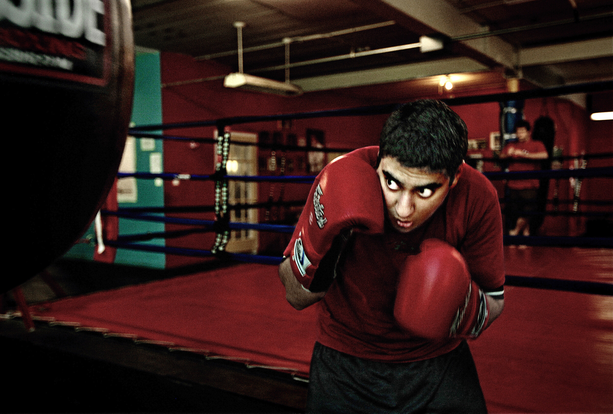   USA. Evanston, Illinois. 2010. Iqbal Shariff practices punch combinations at the Ultimate Fitness gymnasium. Iqbal said, “As a child I always thought that a situation similar to the French revolution would occur in my neighborhood and people will t