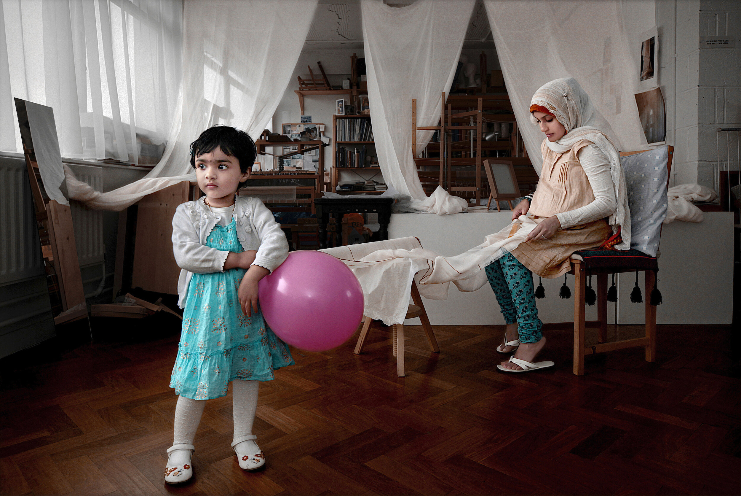   UK. London. 2011. Rezia Halima Wahid [right] and her 3-year old daughter, Noorie, at Rezia's studio. Rezia is a textile artist and creates hand-woven textiles. Rezia said, “Islam is a part of me, my existence, but my spirituality is something very 