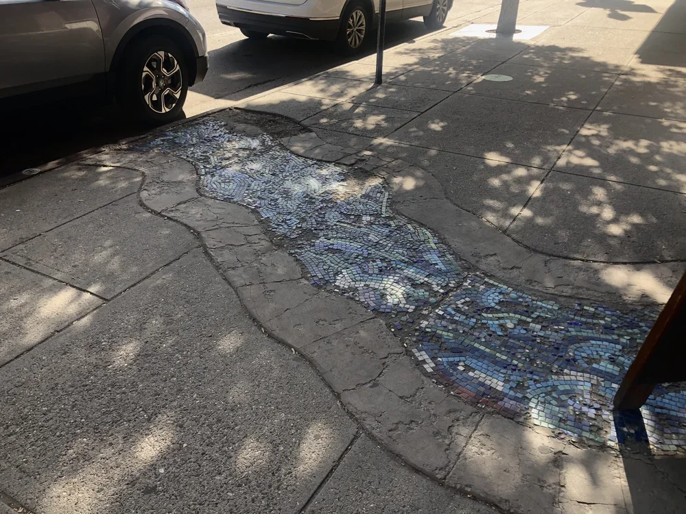 The mosaic on Main Street— Bozeman creek is right underneath your feet!