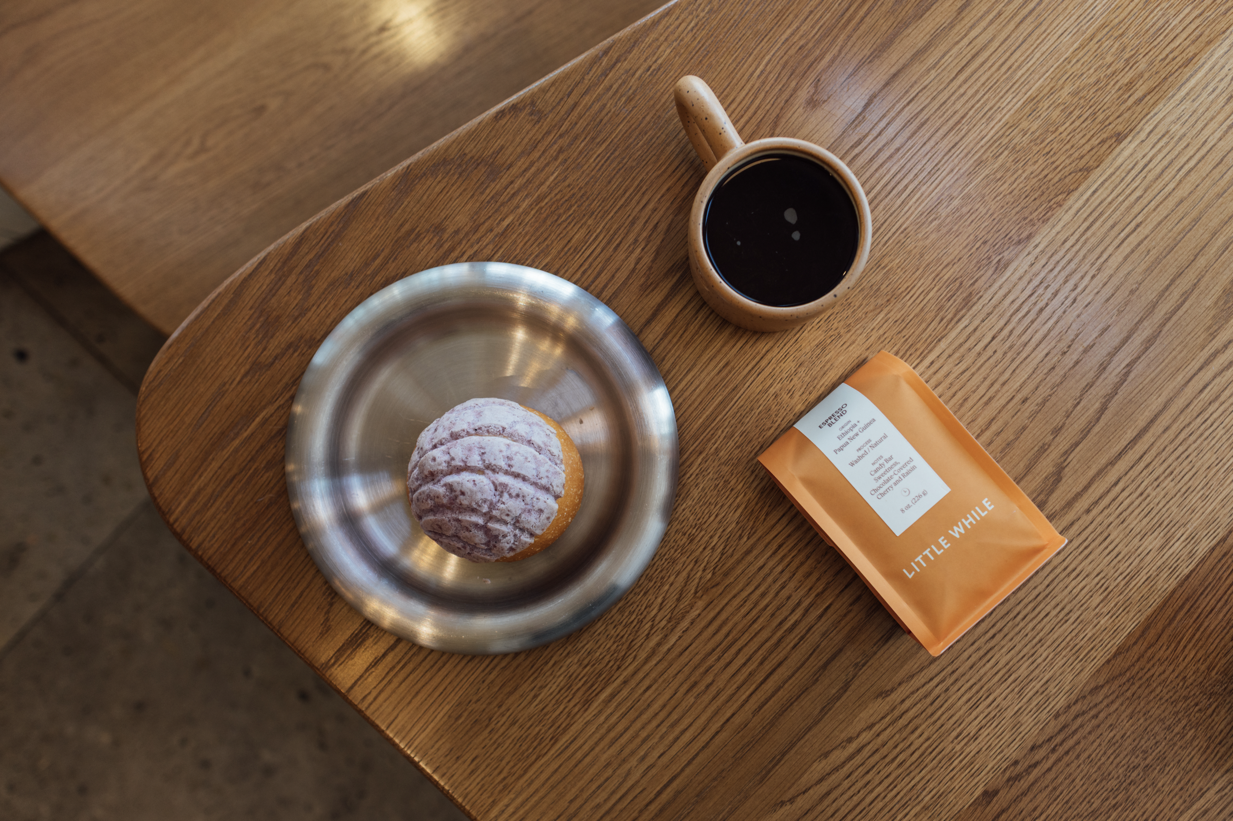 Little While Coffee Bag, Pastry and mug of coffee
