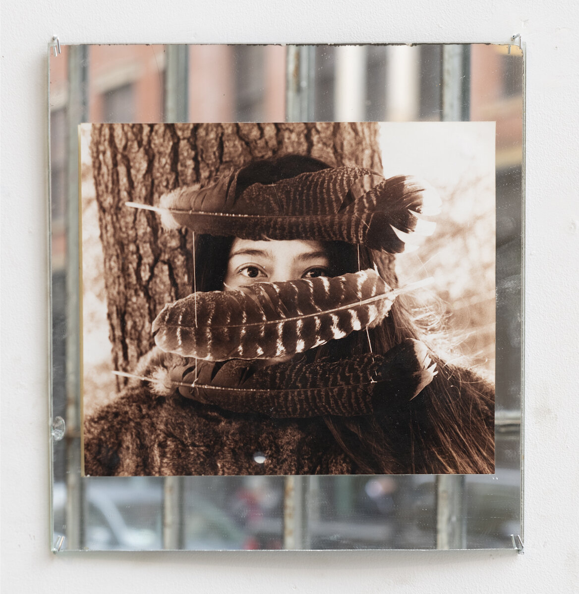   Feather Mask , 2002, sepia-toned photograph on mirror, 11.5 x 11.5 in, Image courtesy of the Sol LeWitt Collection 