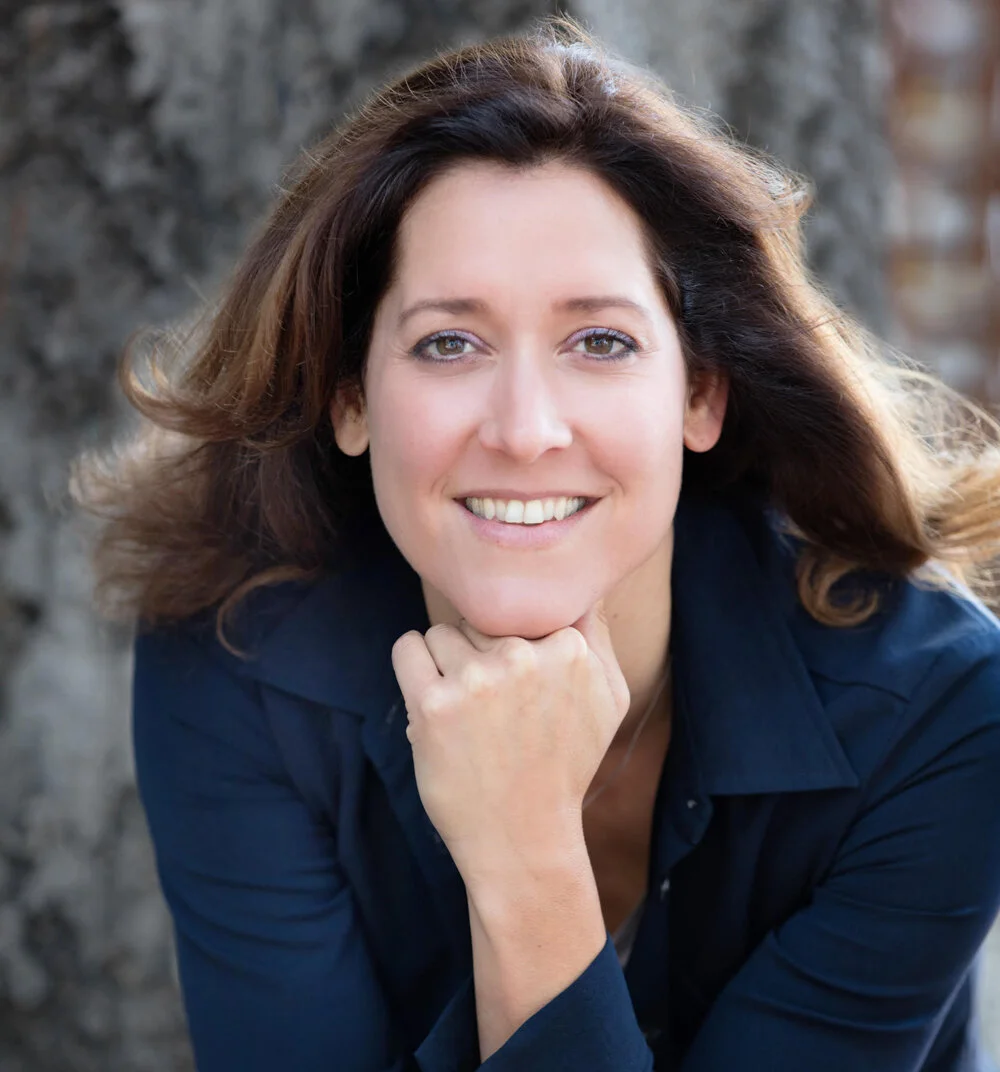 Woman with chin on hand.