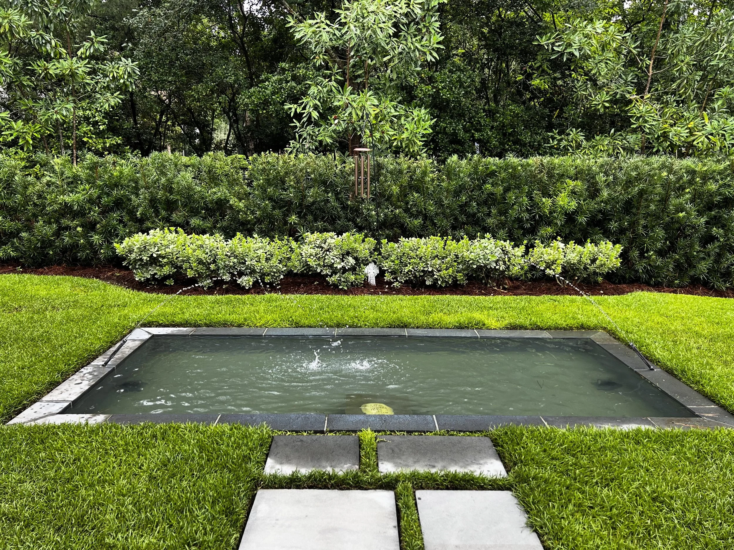 The sound of water and an evergreen backdrop make this water feature special in all seasons.