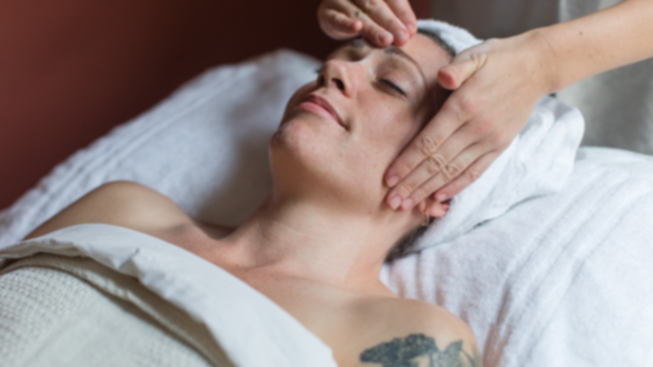 Person receiving facial massage in a spa setting