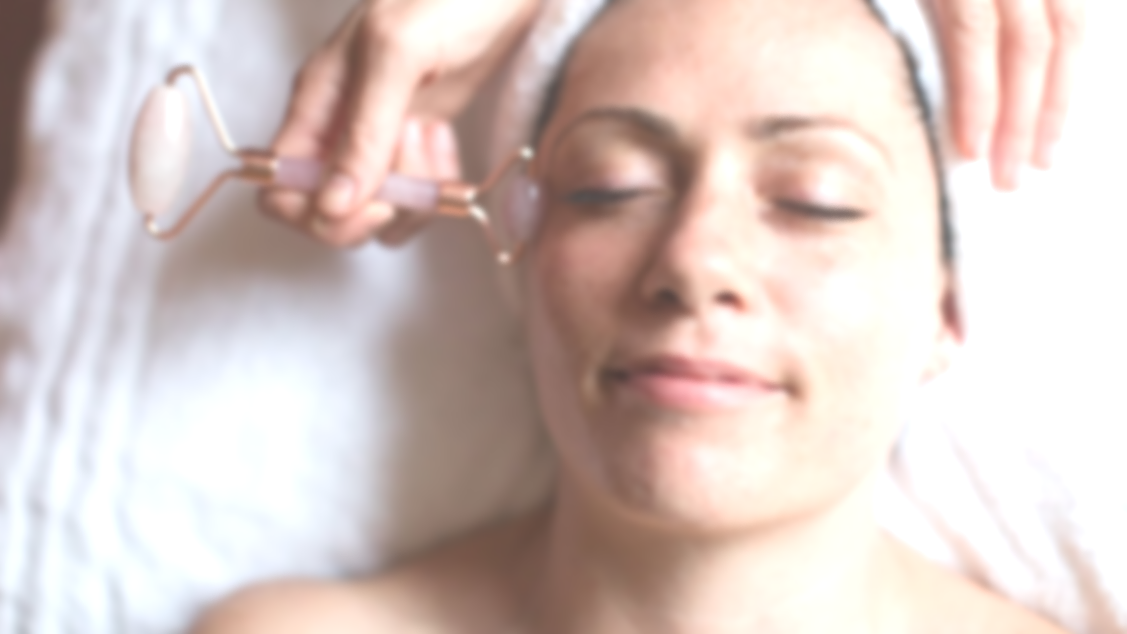 A woman receiving a facial facial massage in a spa or beauty treatment setting