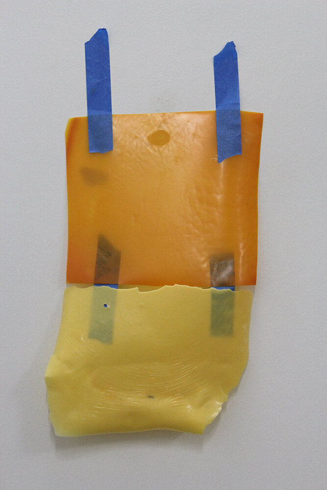 two types of glue taped together and to a surface 