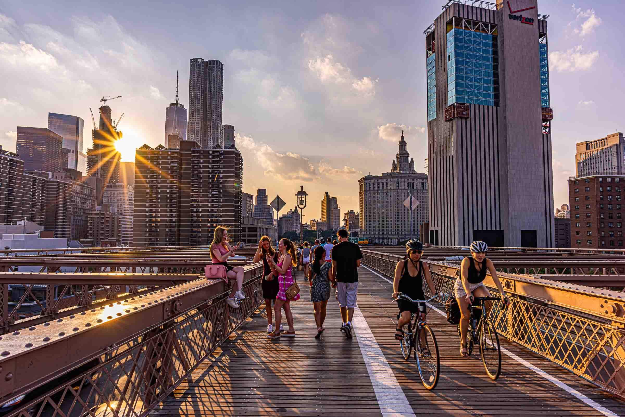 people riding bikes on the brooklyn bridge