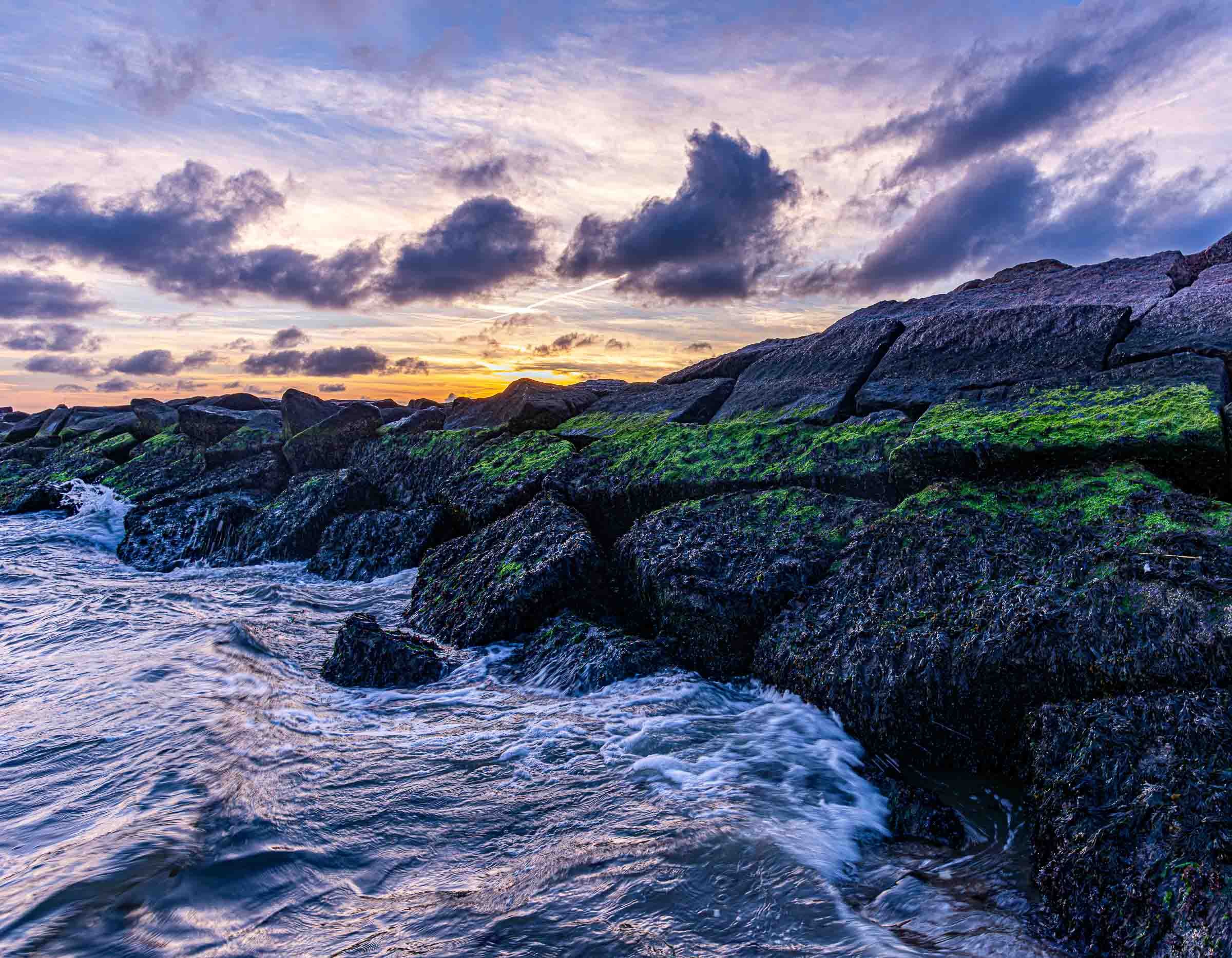 algae covered rock pier at hammonasset