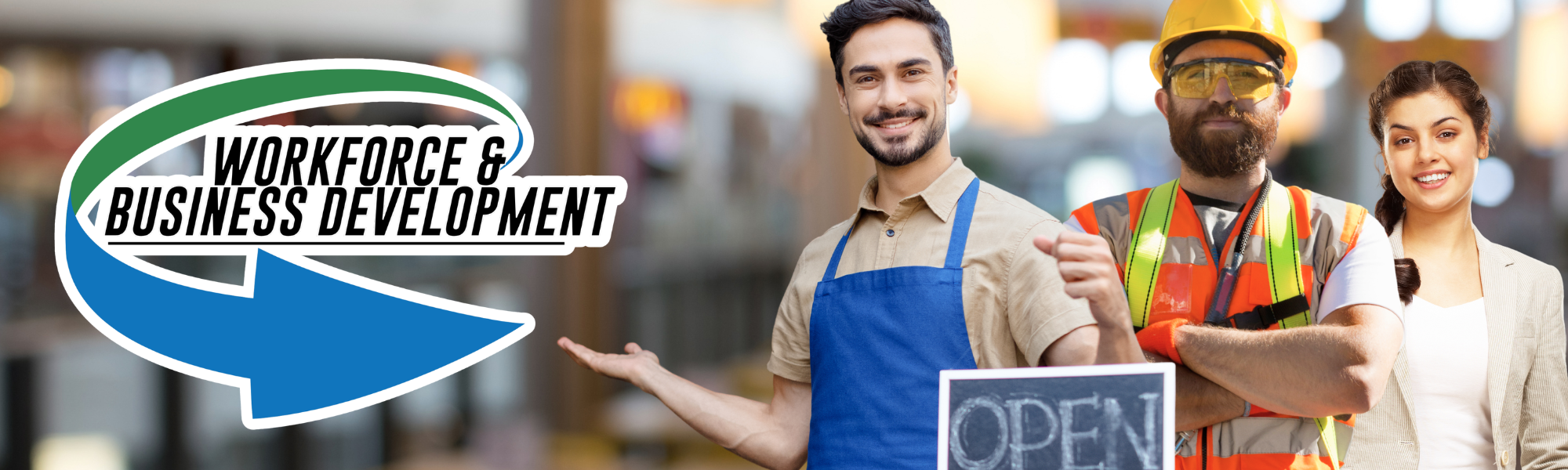Three diverse people smiling, standing in a business setting with a sign that says 'Open.' One is wearing a construction helmet and safety vest, another is in an apron, and the third is in a blazer. They are promoting workforce and business development.