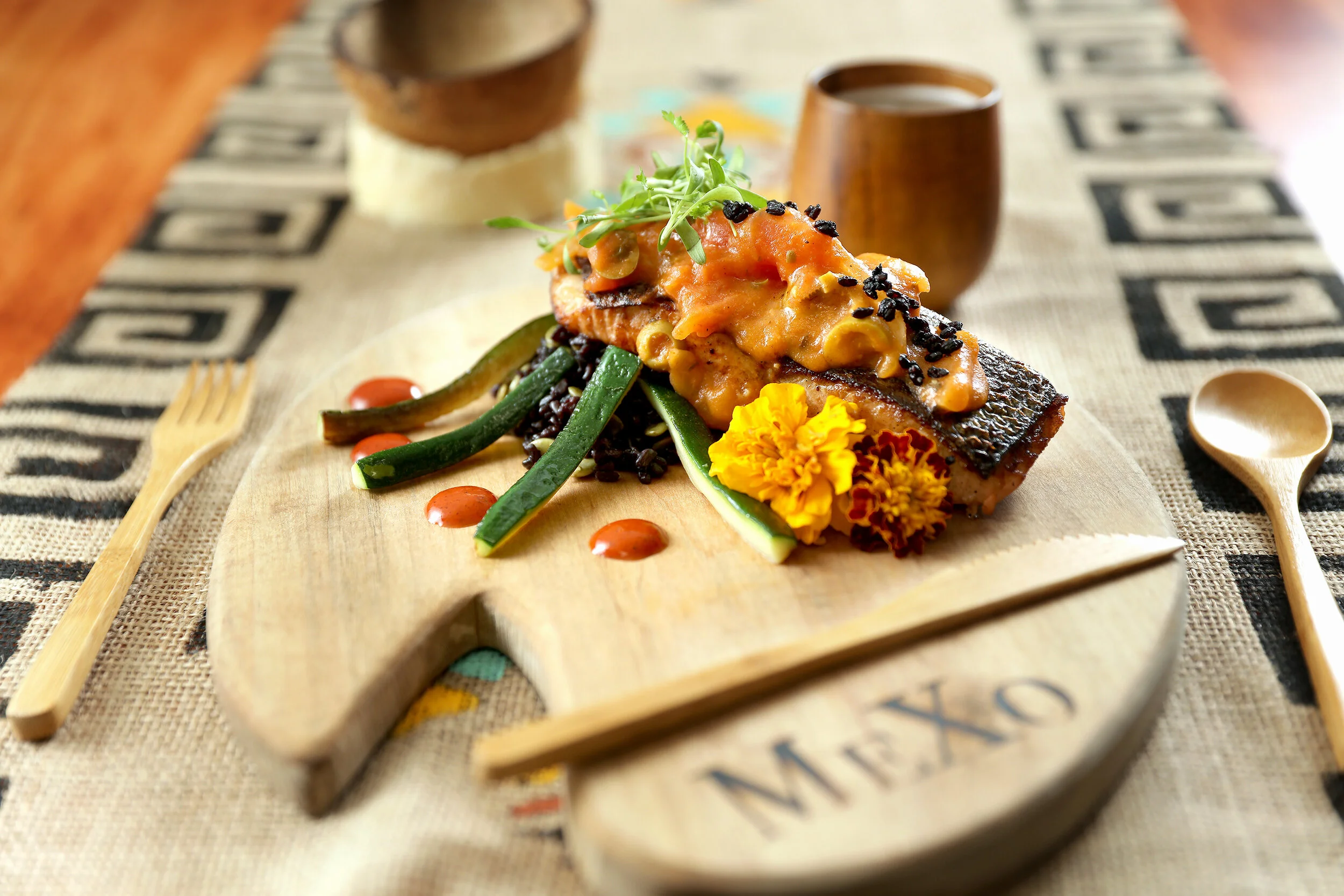A MeXo salmon dish finished with edible flowers and seasonal accompaniments