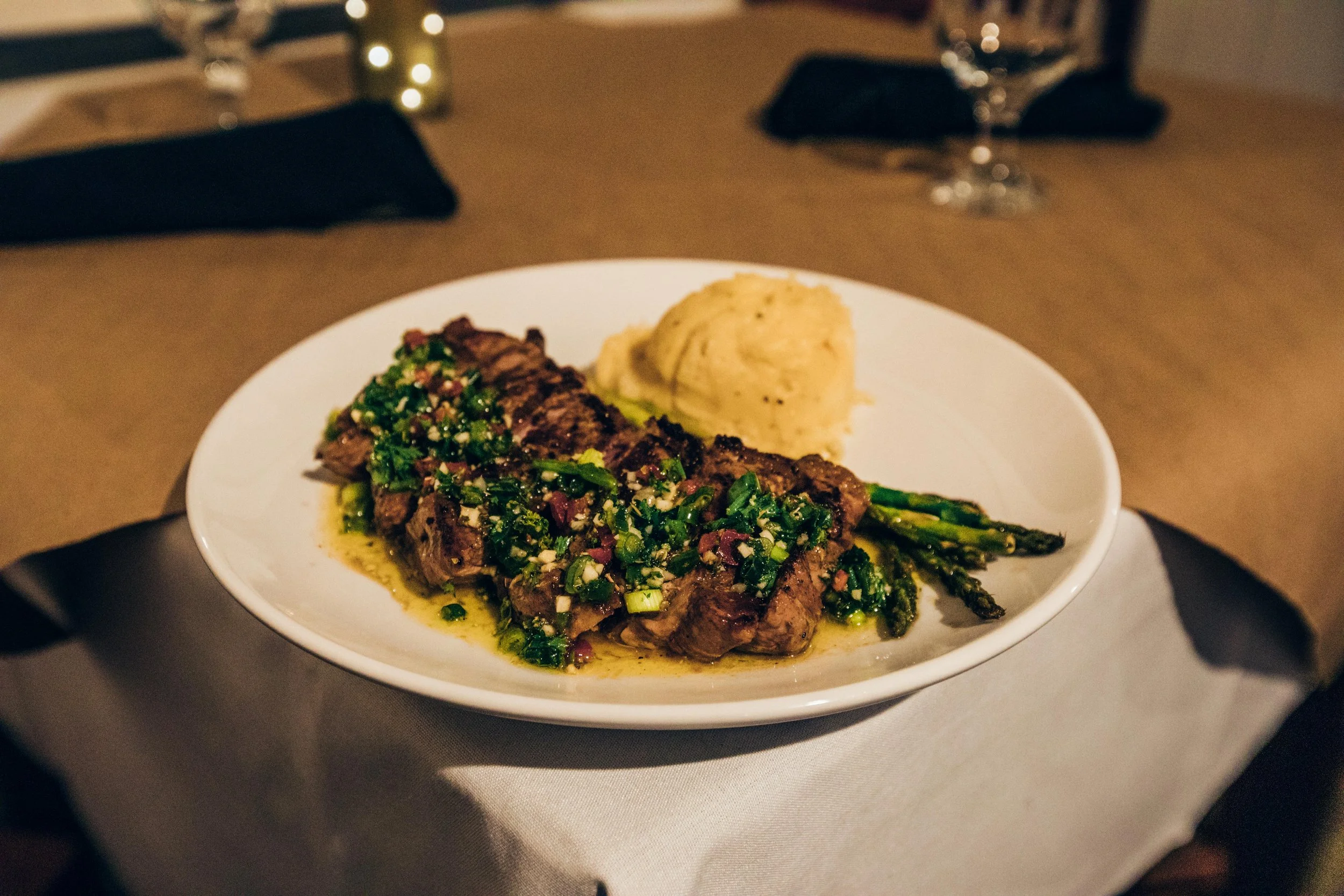 Steak with herb sauce, asparagus and mashed potatoes at Sandy Point Beach House