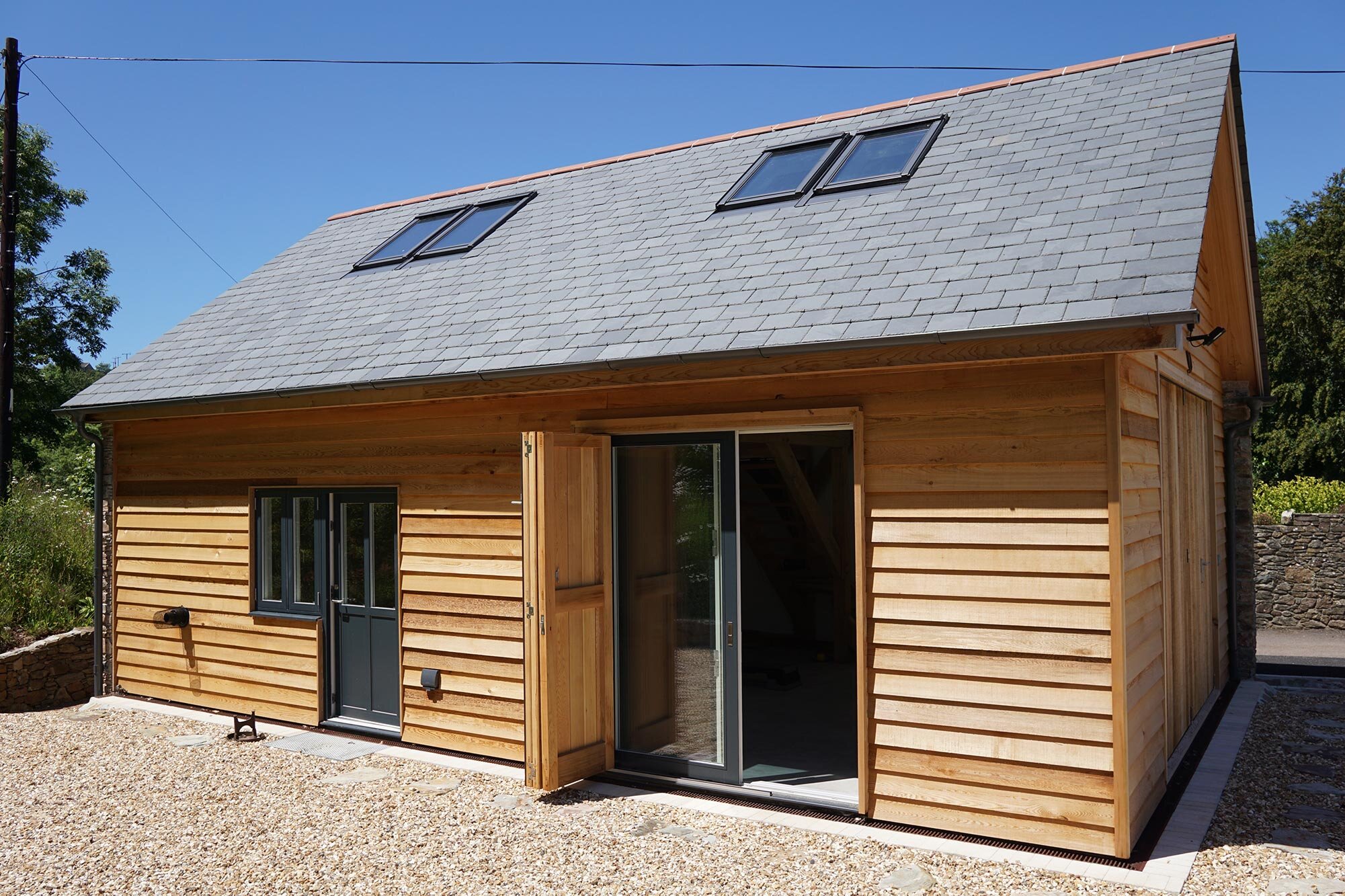 Timber framed garage and workshop with open bifold doors