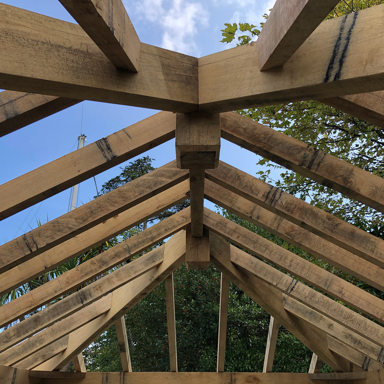 Fully hipped Oak frame roof and sky beyond