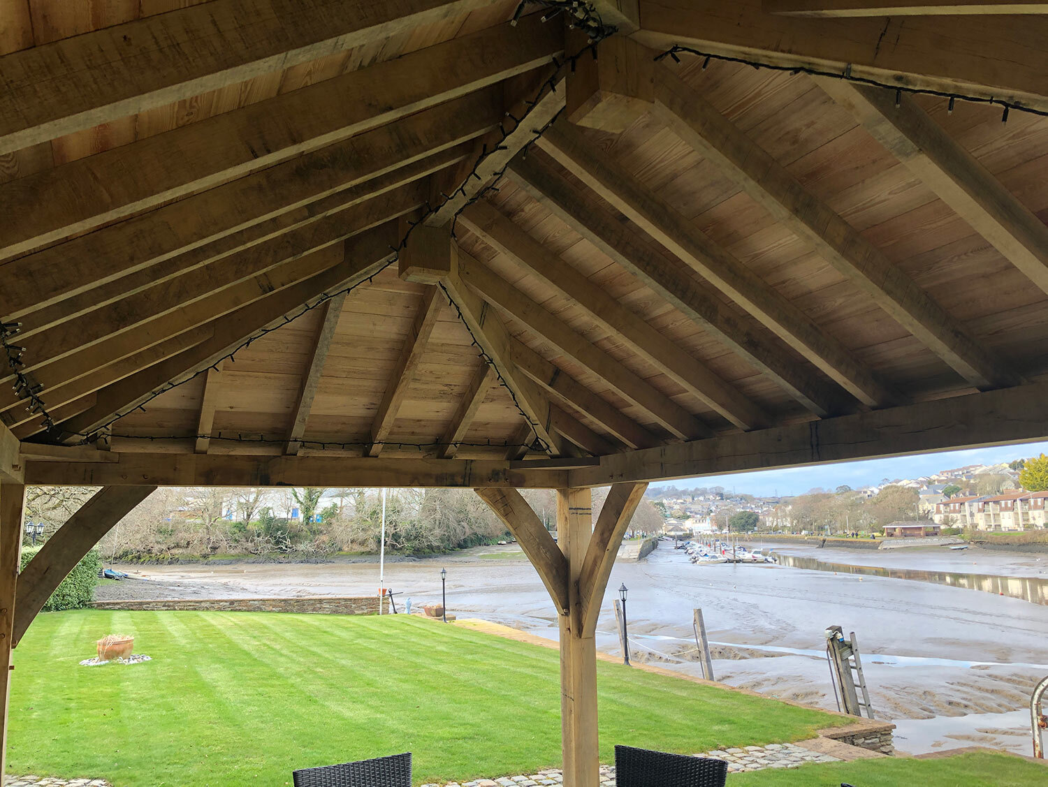Views over Kingsbridge estuary through green oak roof lined with timber sarking boards
