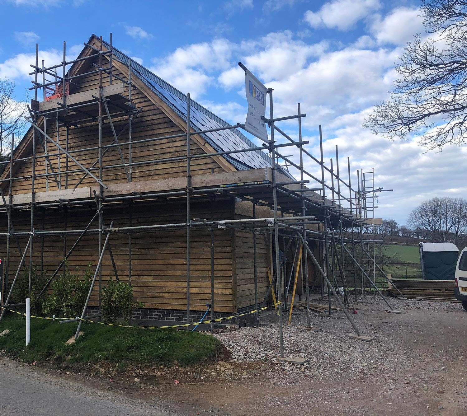 Timber garage with scaffolding surrounding