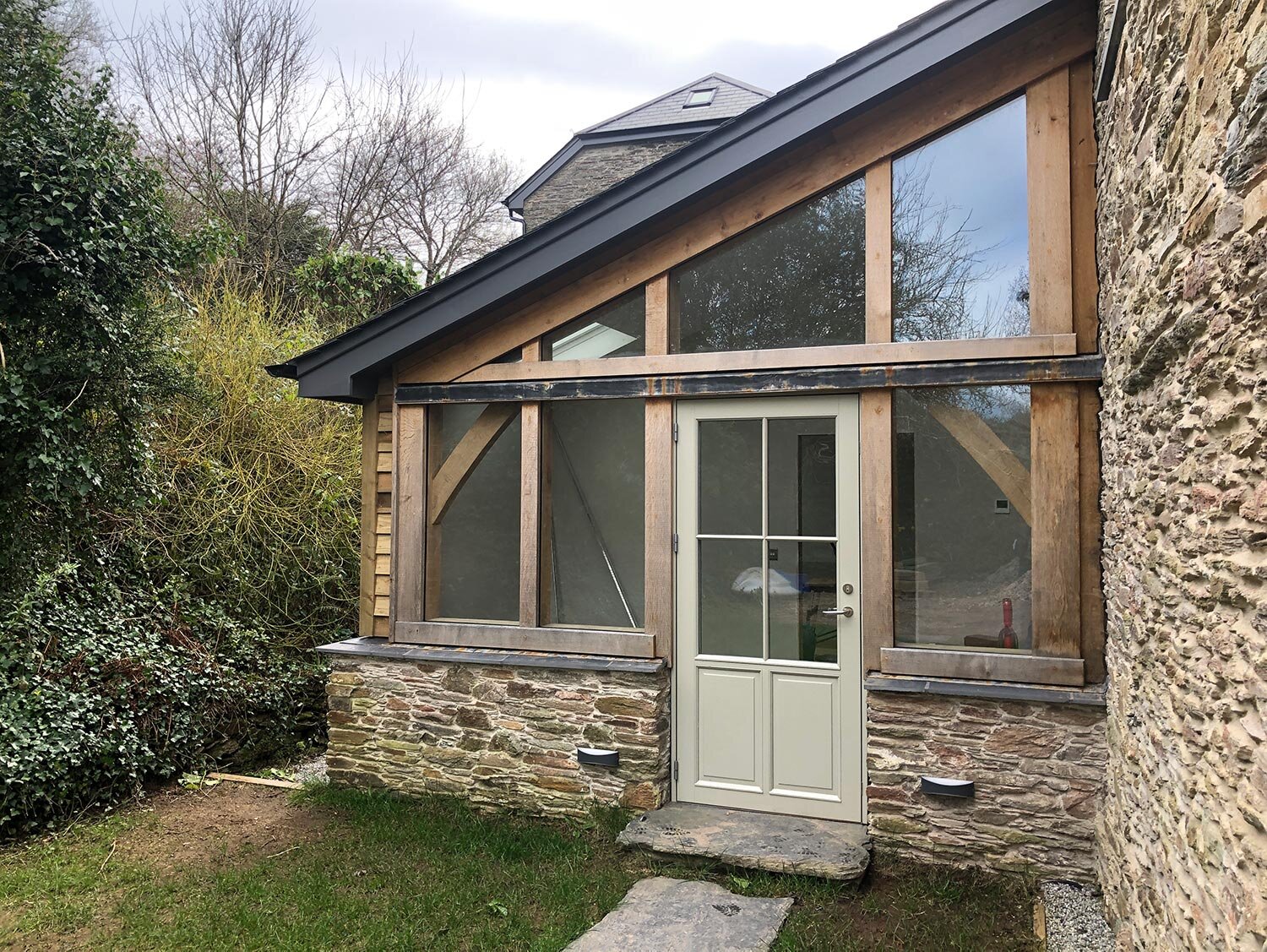 Green oak framed extension with windows in Kingsbridge