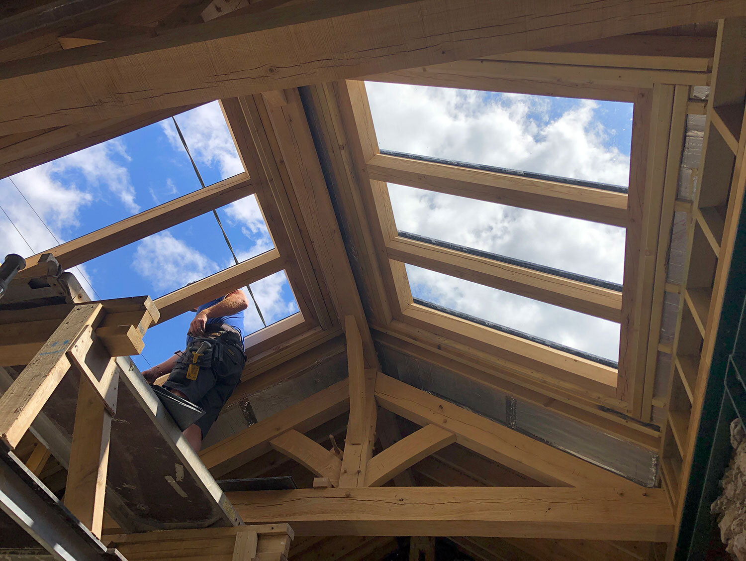 Green oak and purlin timber roof with windows and man