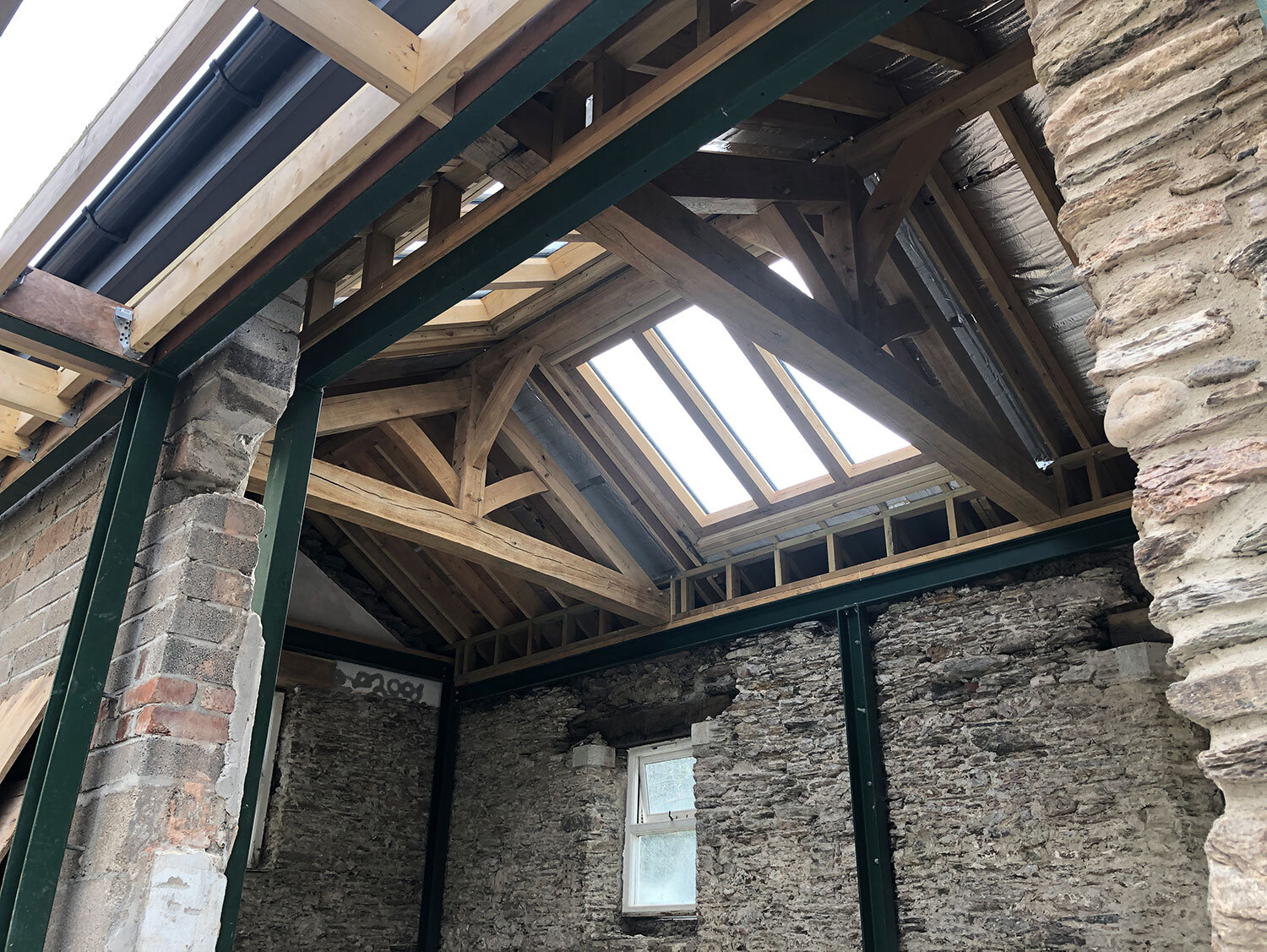 Oak truss and purlin roof on old stone mill